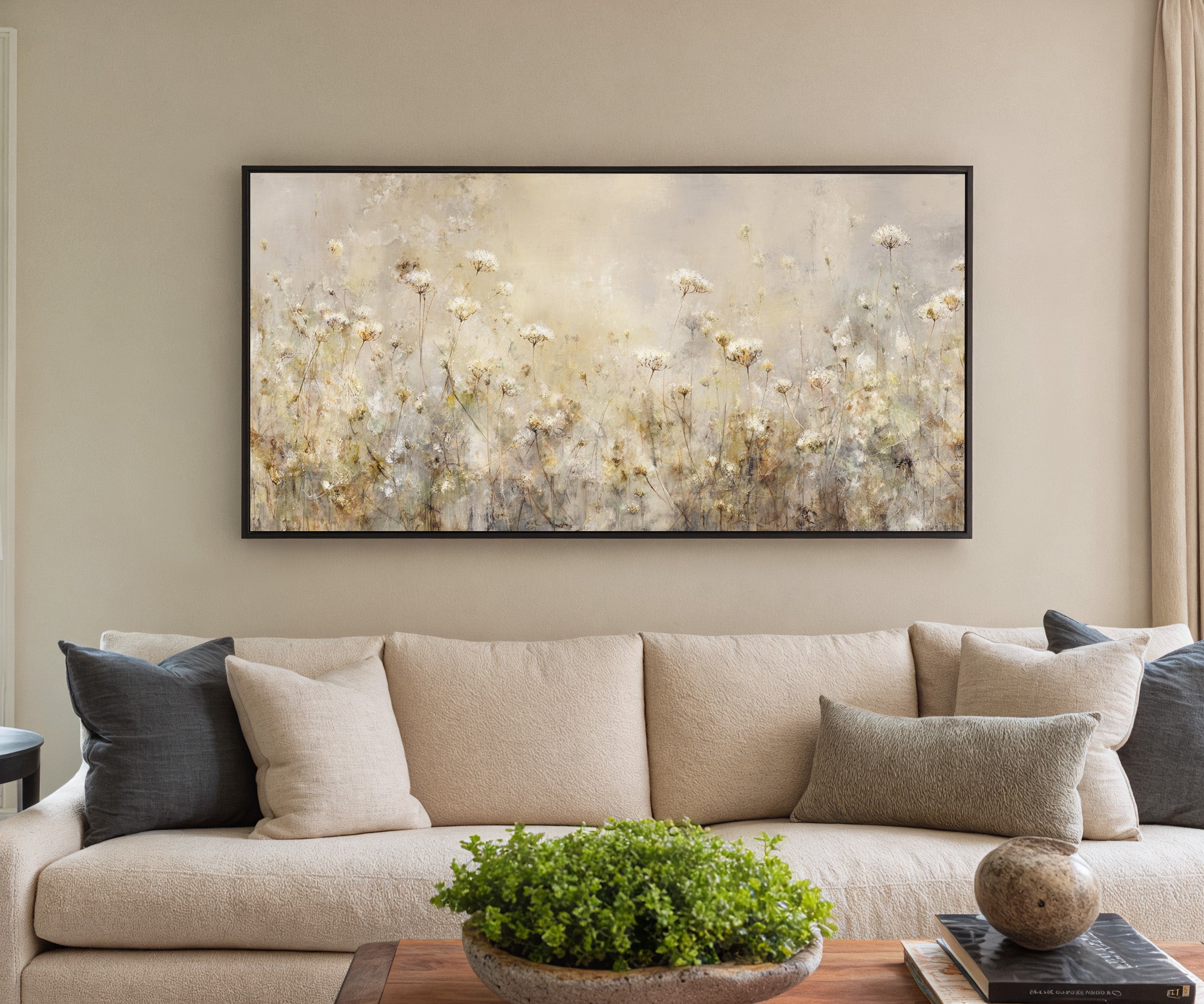 pale wildflower meadow with tall stems and soft canvas wall art in a black frame in a styled room setting