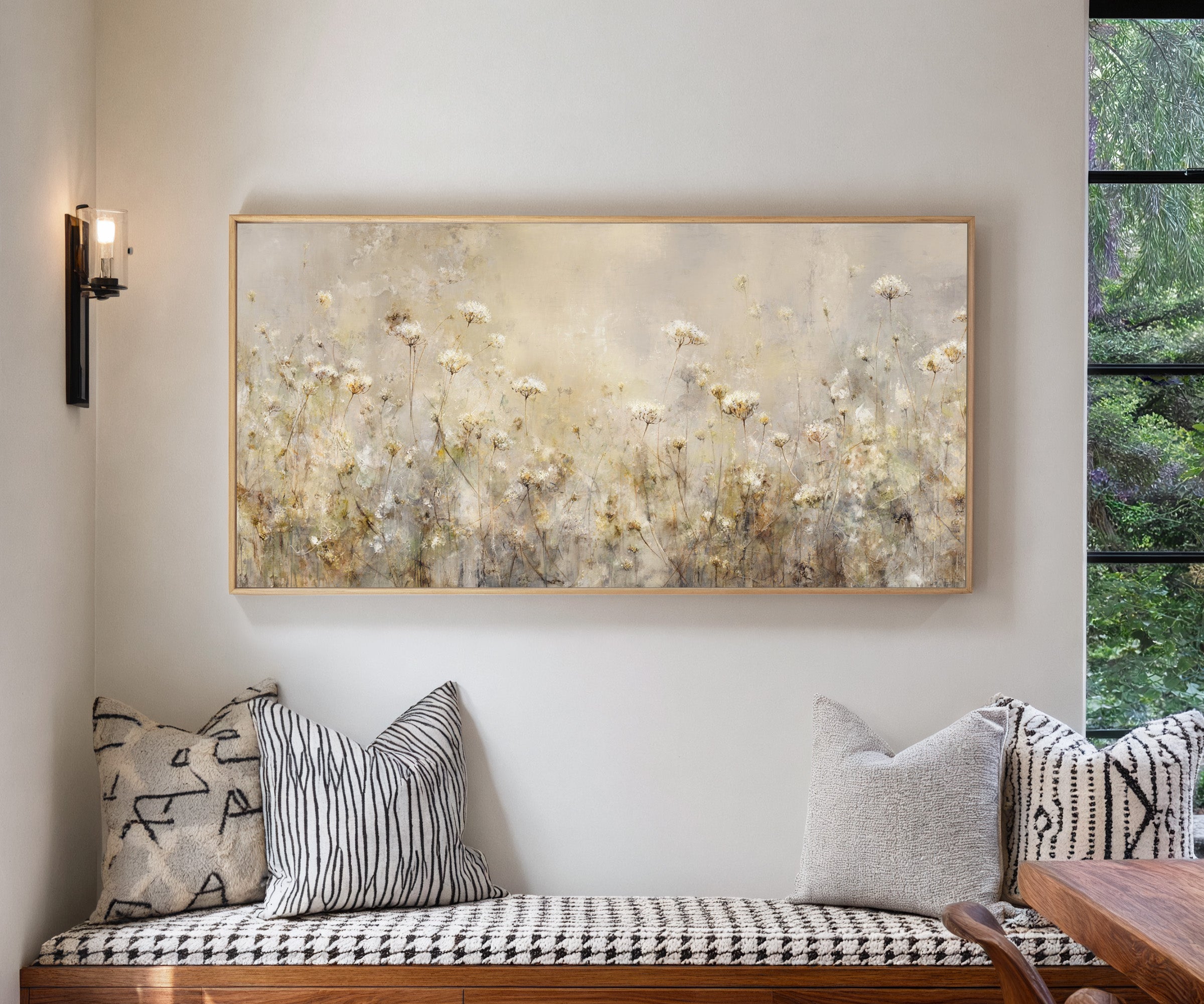 pale wildflower meadow with tall stems and soft canvas wall art in a natural wood frame in a living room