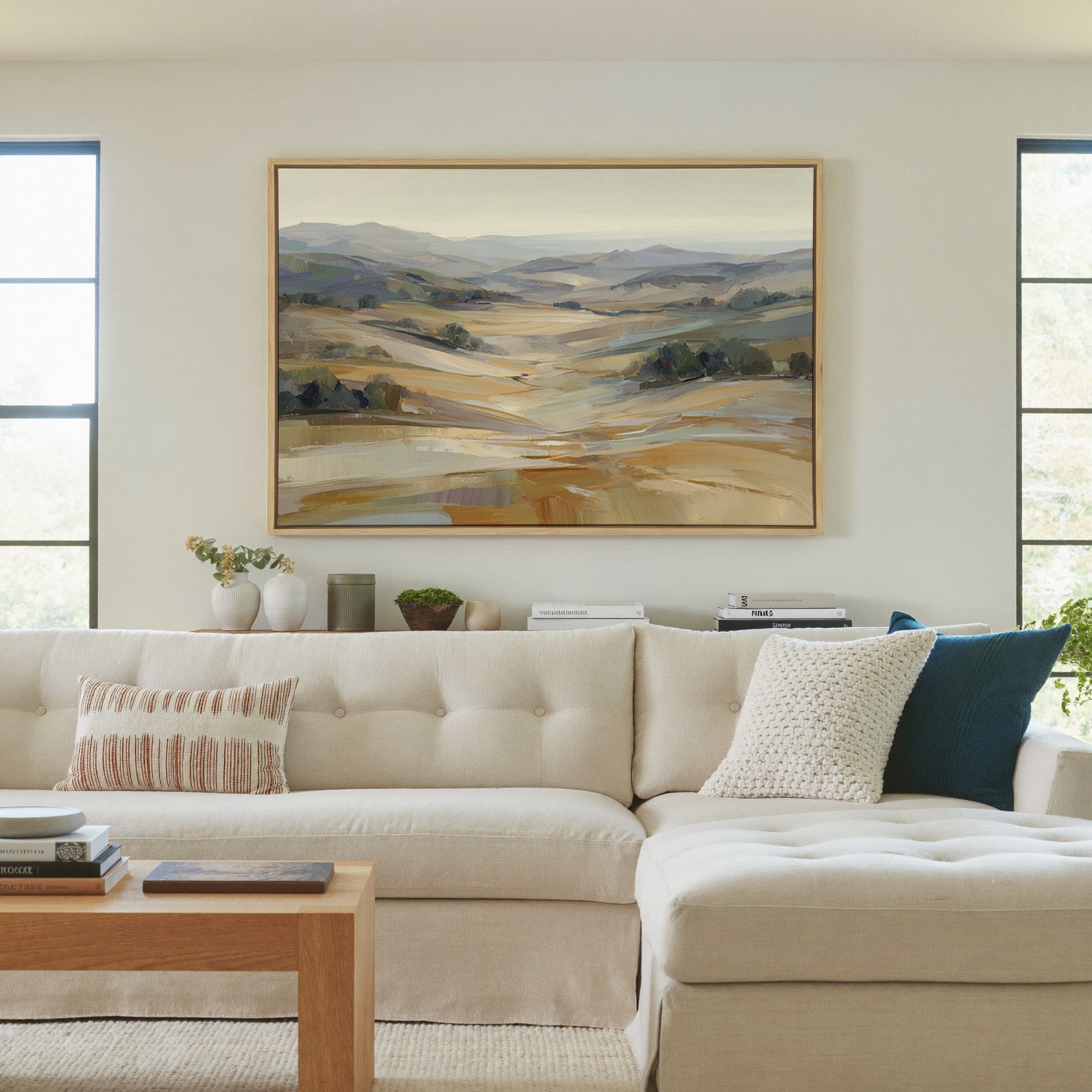 pale rolling hills and valley in cream, gold, canvas wall art in a natural wood frame in a living room