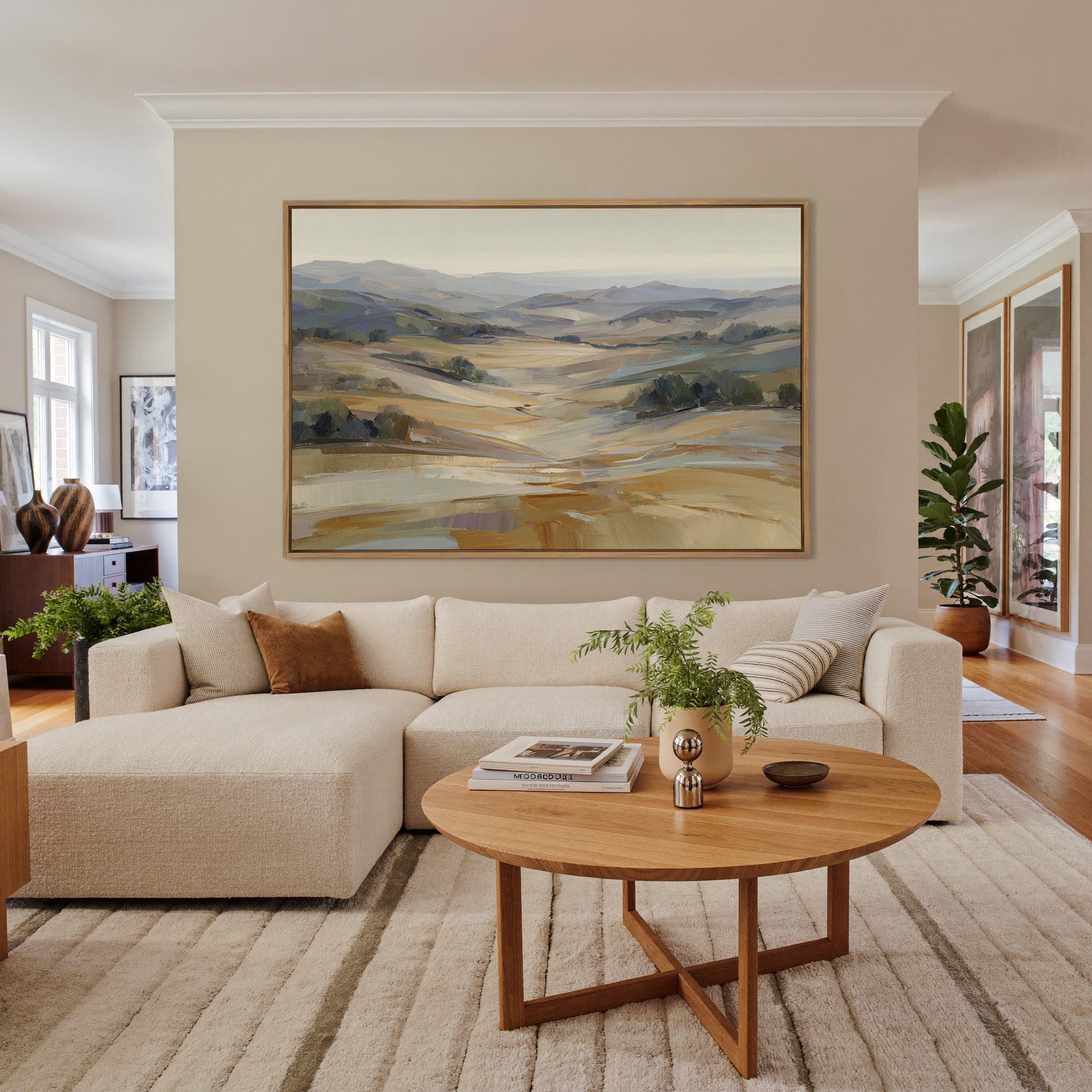 pale rolling hills and valley in cream, gold, canvas wall art in an oak frame in a living room