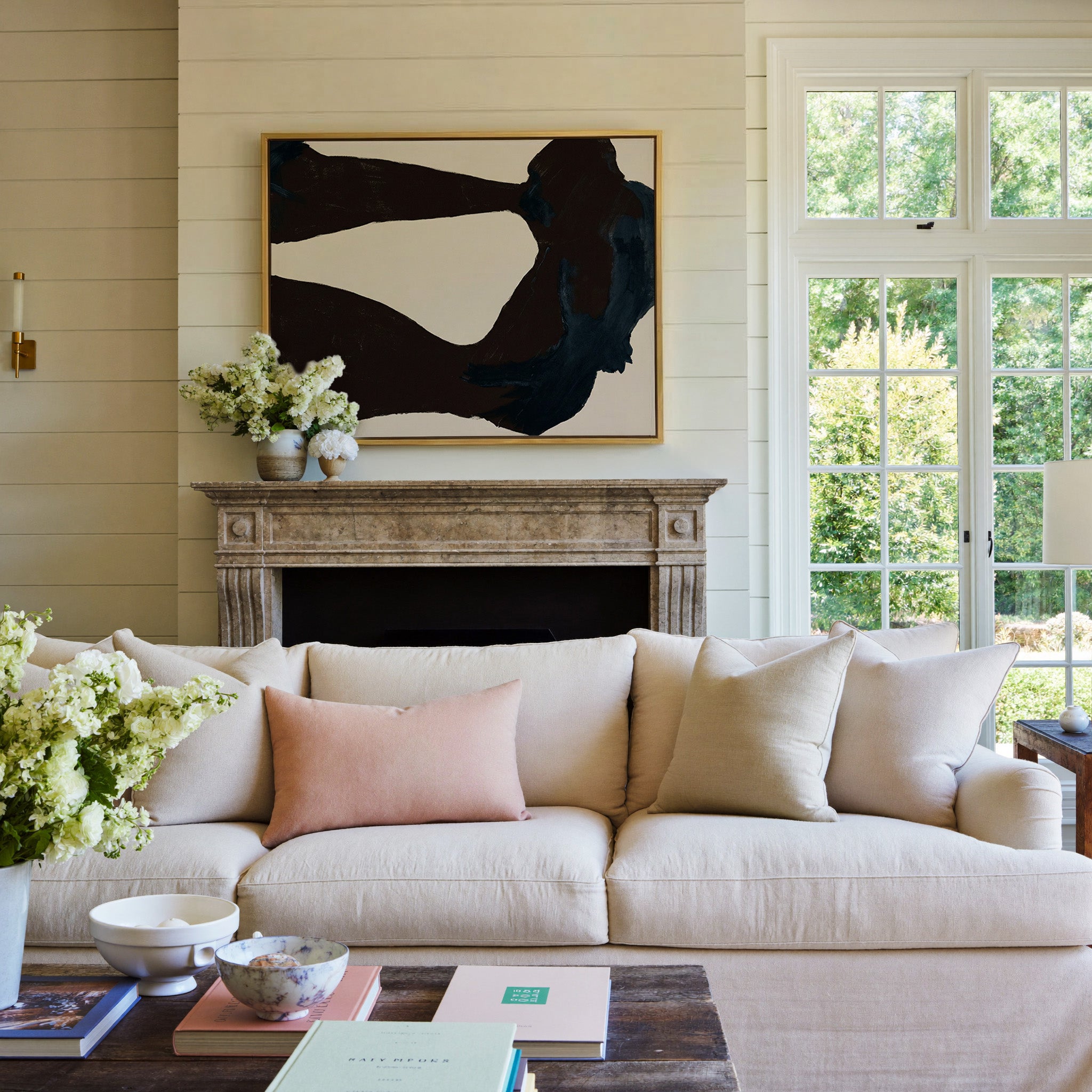 dark charcoal and deep blue abstract with broad canvas wall art in a gold frame above a mantel