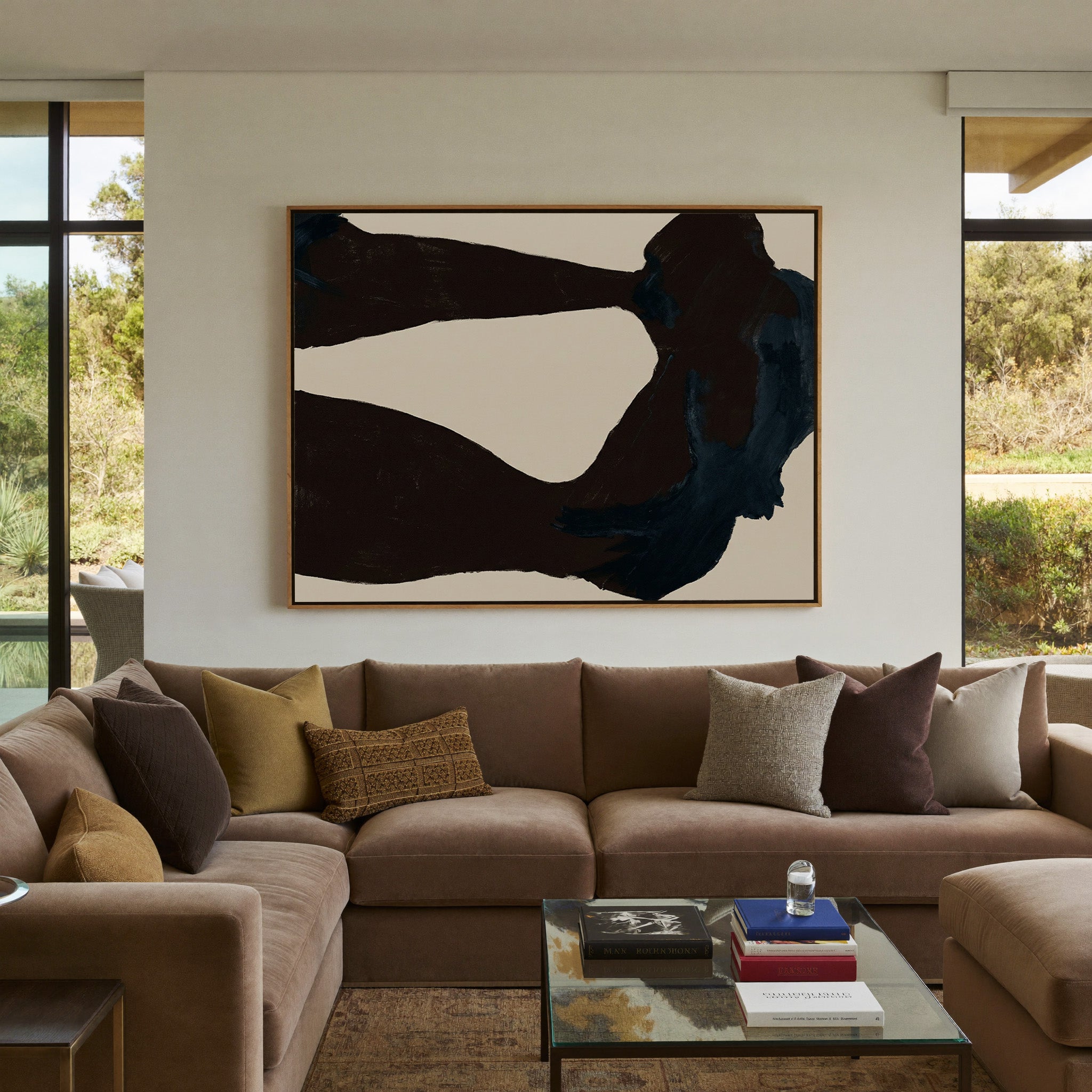 dark charcoal and deep blue abstract with broad canvas wall art in an oak frame in a styled room setting
