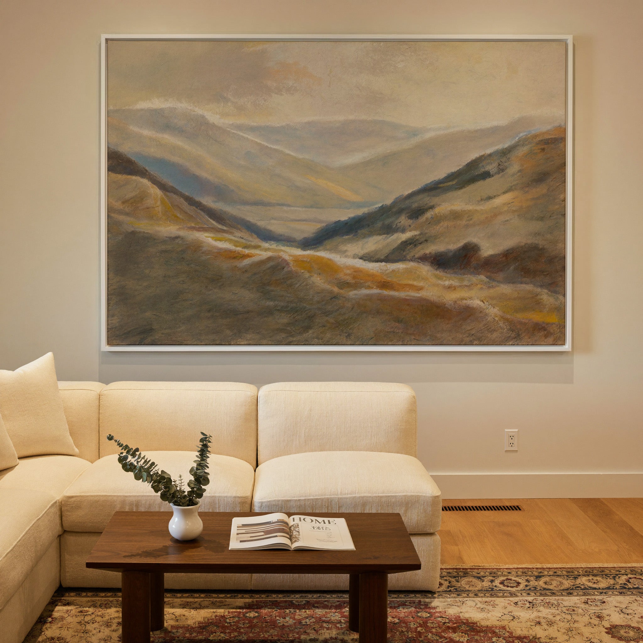 soft beige and blue mountain landscape canvas wall art in a white frame in a styled room setting