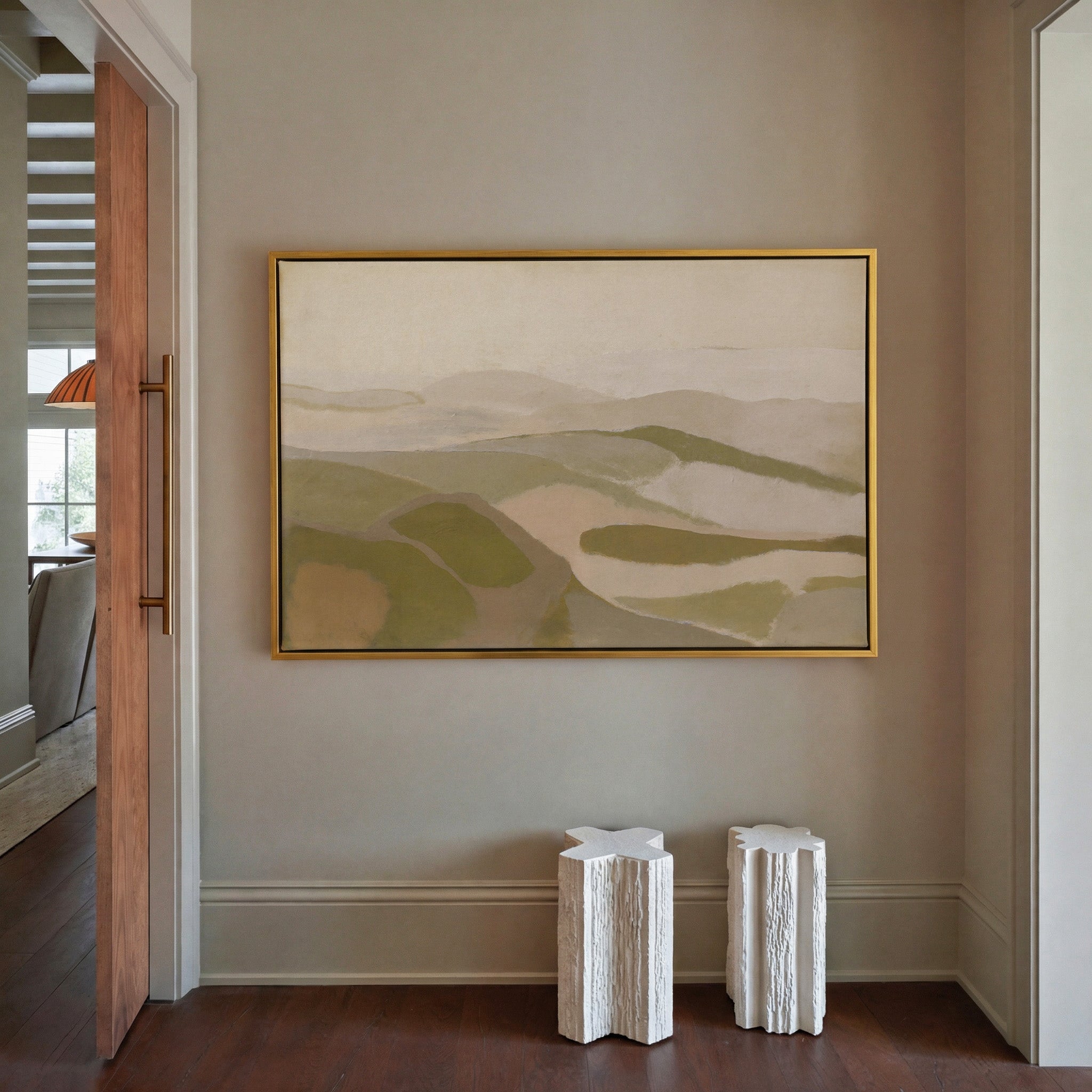soft beige and olive abstract with layered canvas wall art in a gold frame in a styled room setting