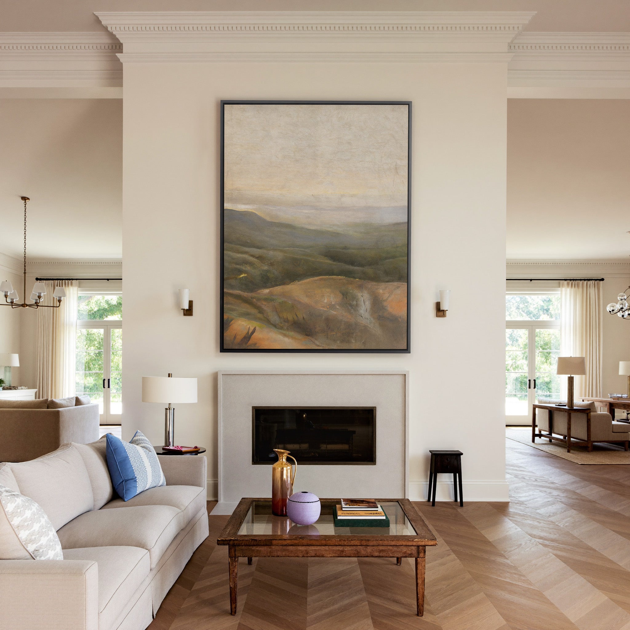 soft beige sky over layered olive and ochre canvas wall art in a black frame above a mantel