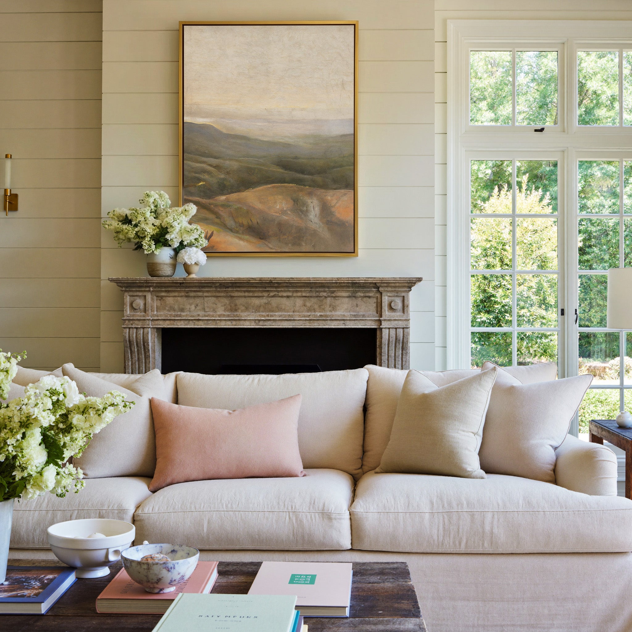 soft beige sky over layered olive and ochre canvas wall art in a gold frame above a mantel