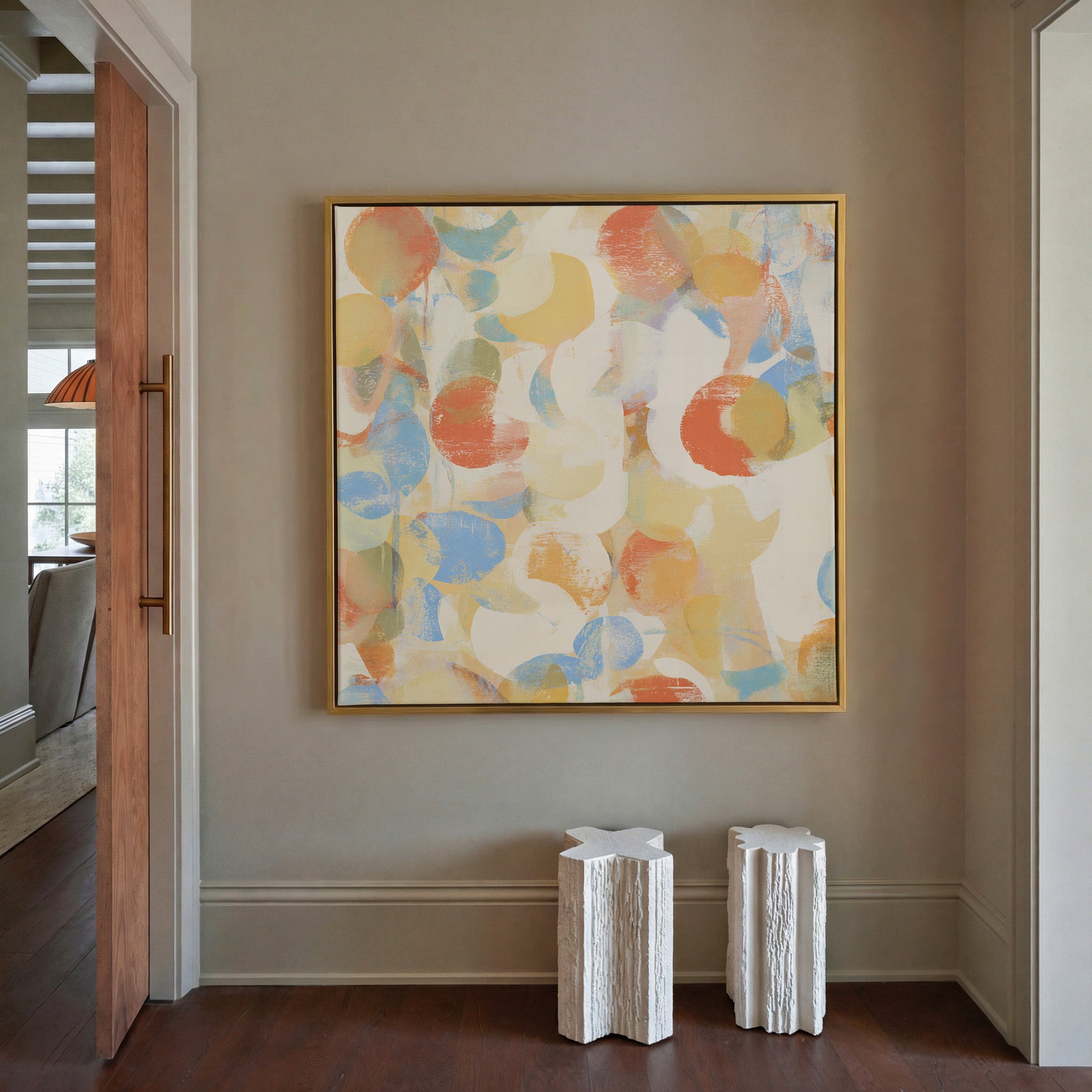 soft pastel circle abstract canvas wall art in a gold frame in a styled room setting