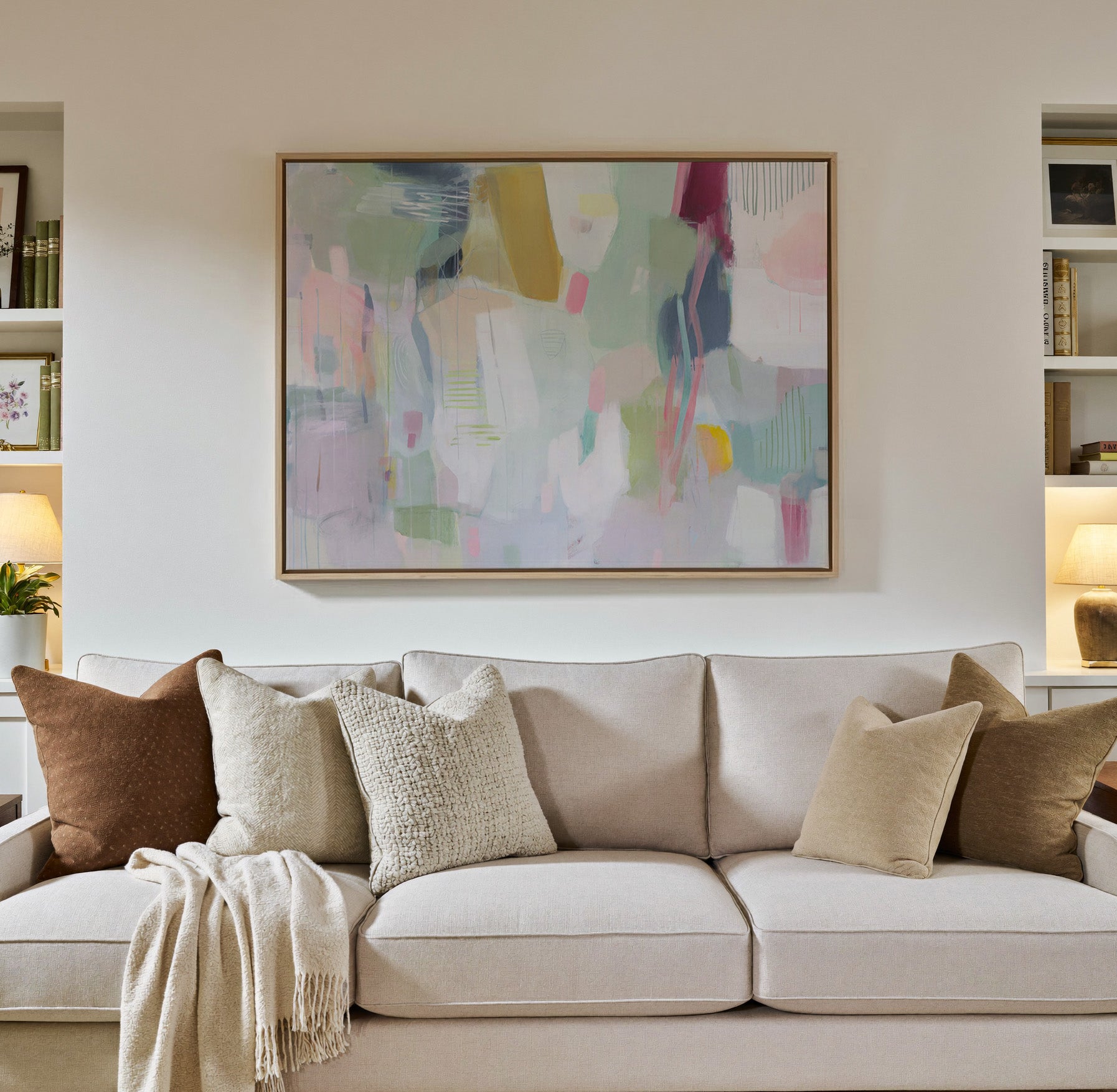 soft pastel abstract with vertical marks and canvas wall art in a natural wood frame in a styled room setting