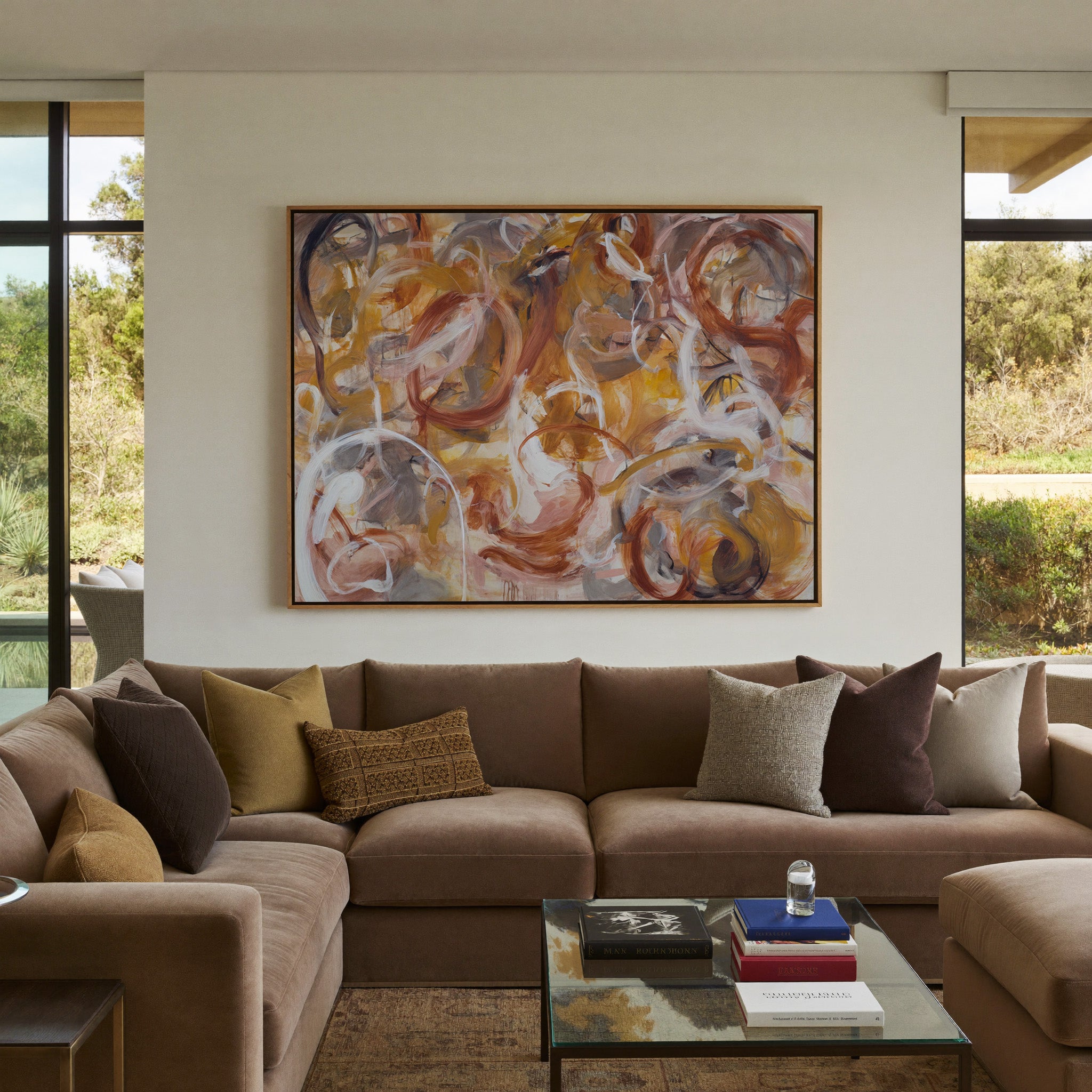 warm rust, gold, cream, and gray abstract with canvas wall art in an oak frame in a styled room setting