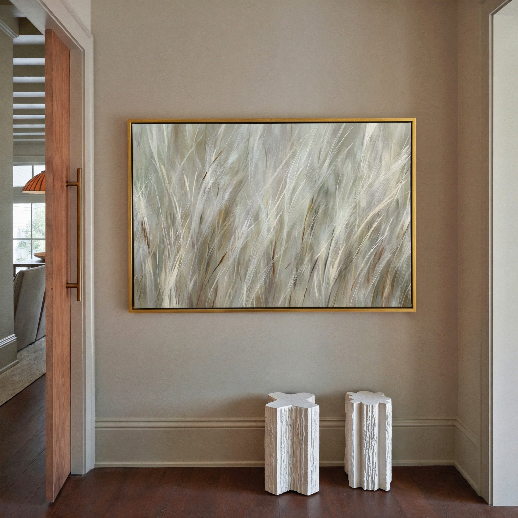 soft beige and cream grass blades canvas wall art in a gold frame in a styled room setting