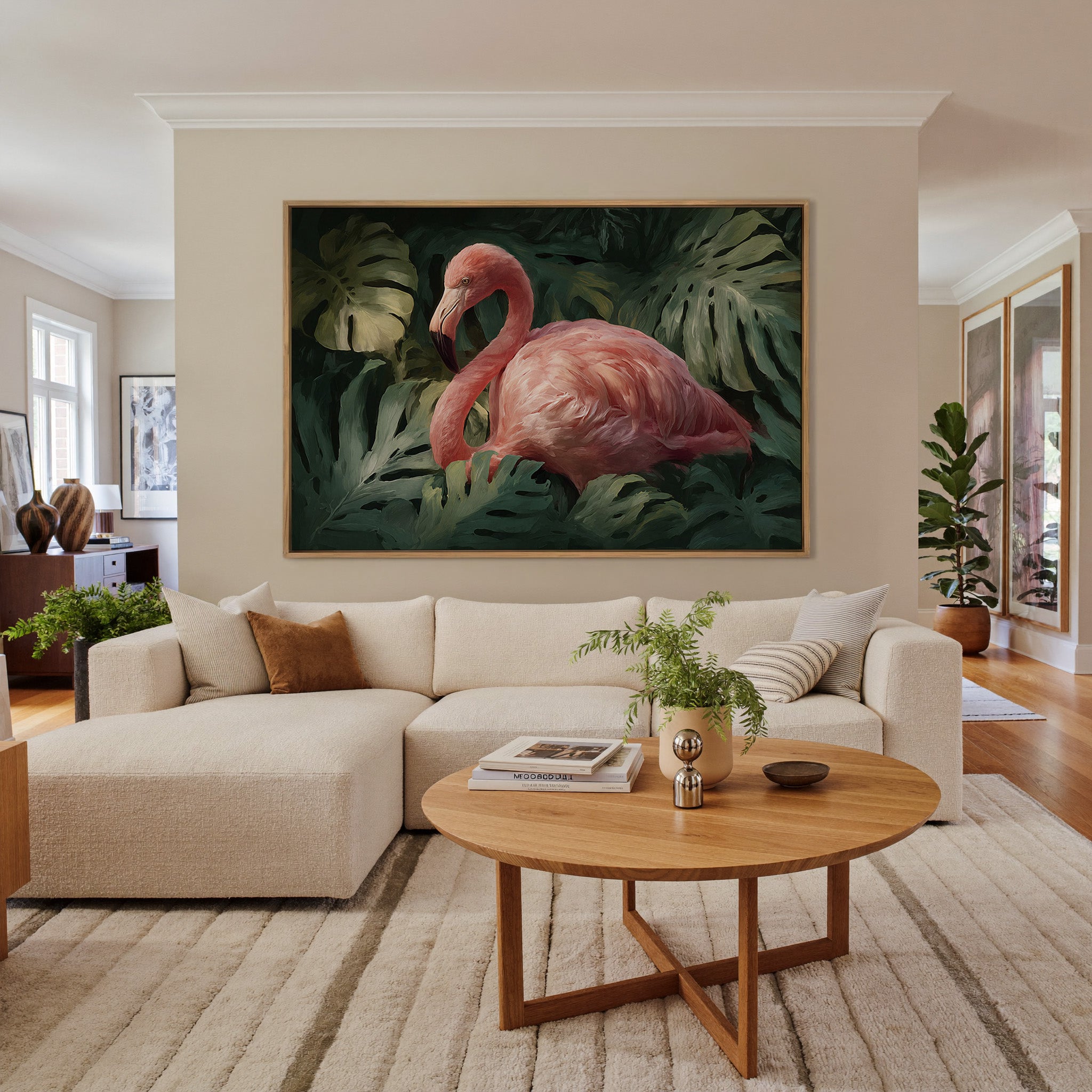 pink flamingo among dark green leaves canvas wall art in an oak frame in a living room