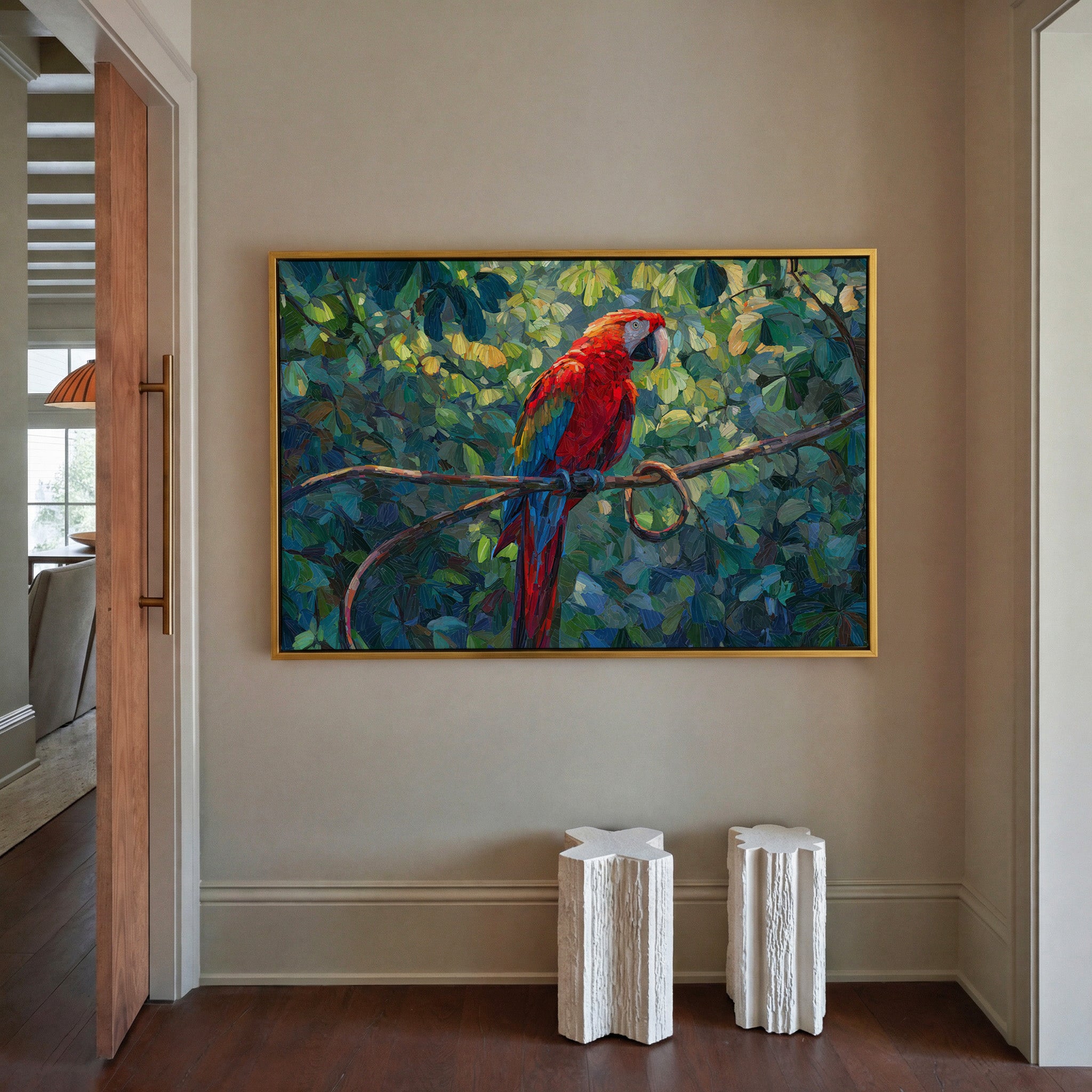 red macaw among dense green foliage canvas wall art in a gold frame in a styled room setting