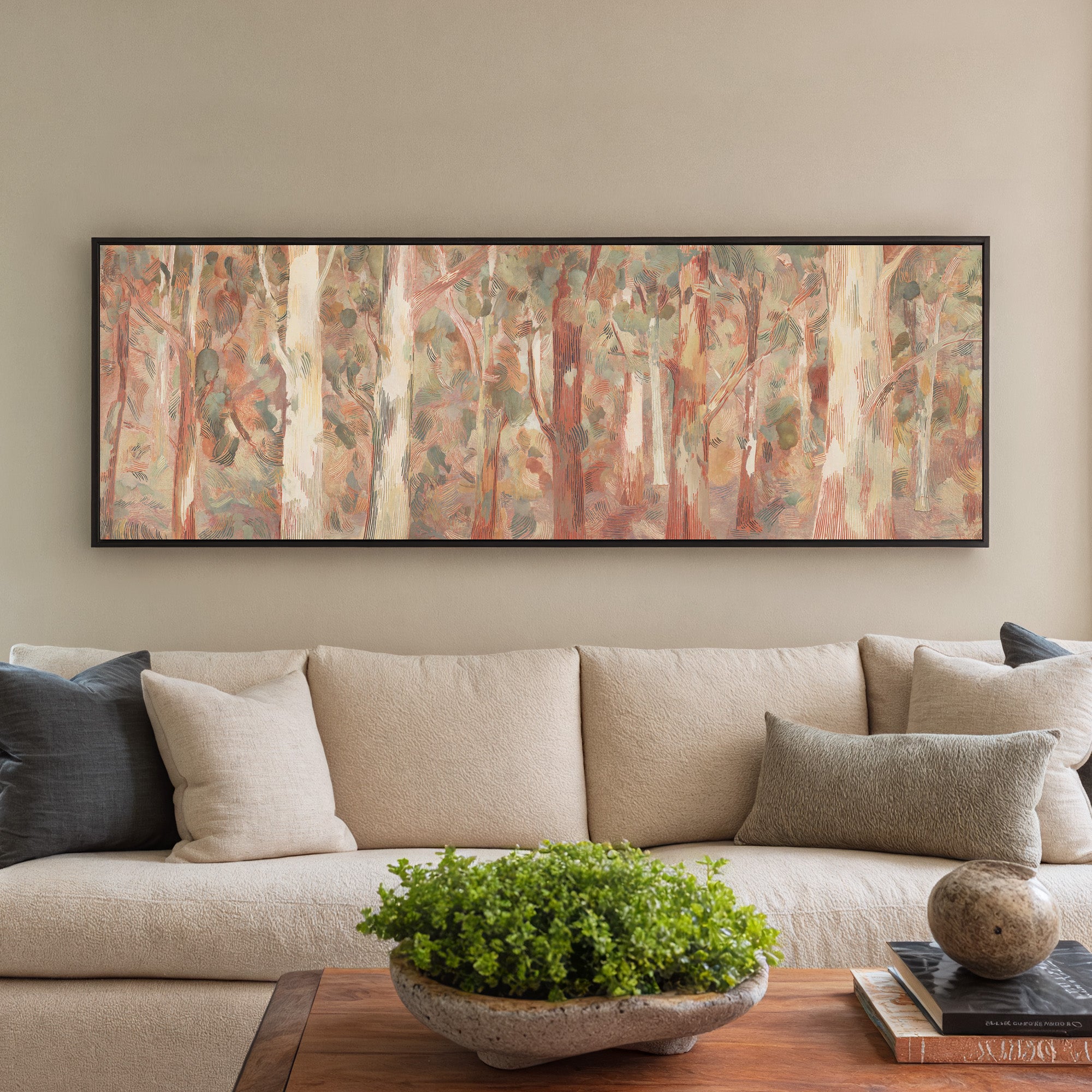soft eucalyptus forest with pale trunks and canvas wall art in a black frame in a styled room setting