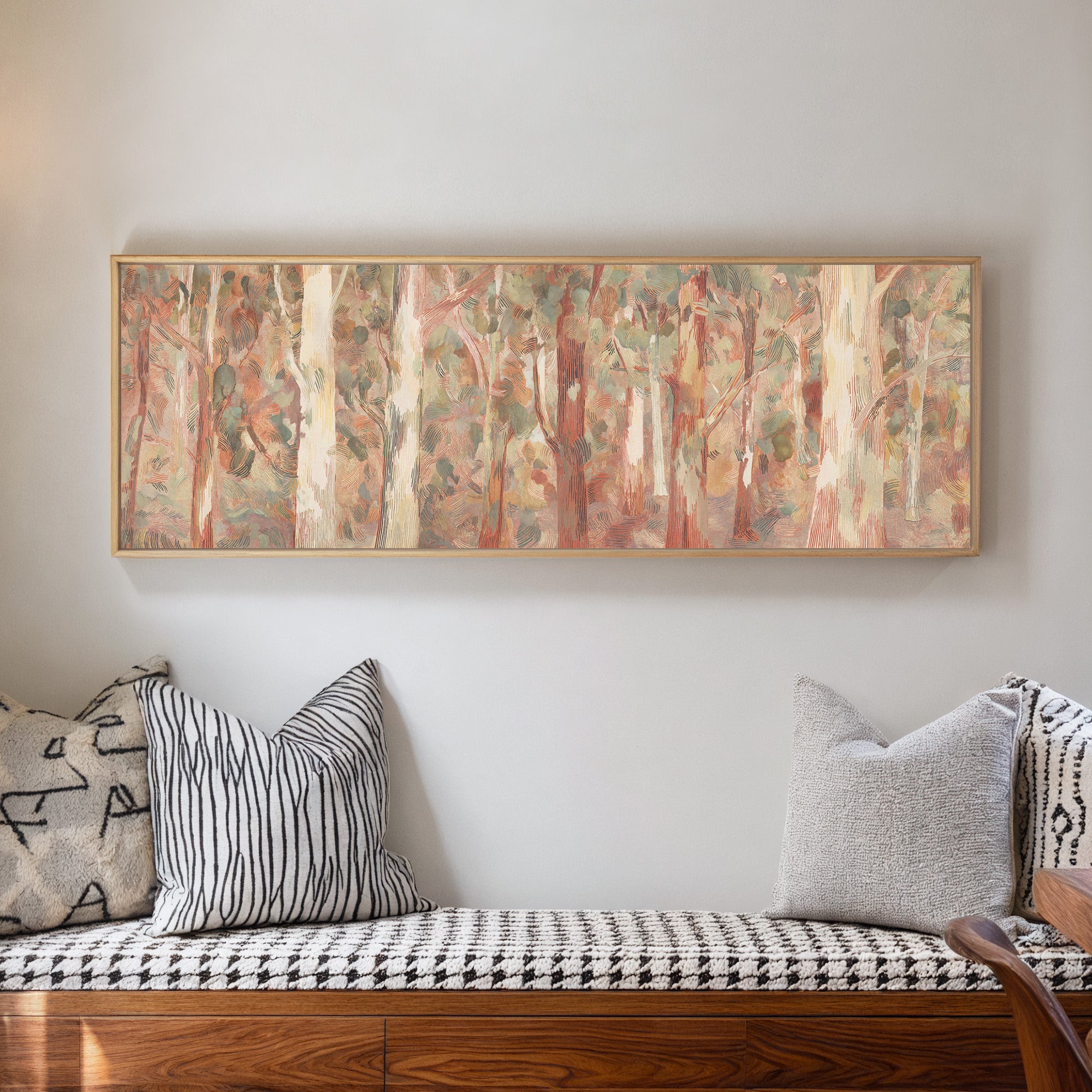 soft eucalyptus forest with pale trunks and canvas wall art in a natural wood frame in a living room