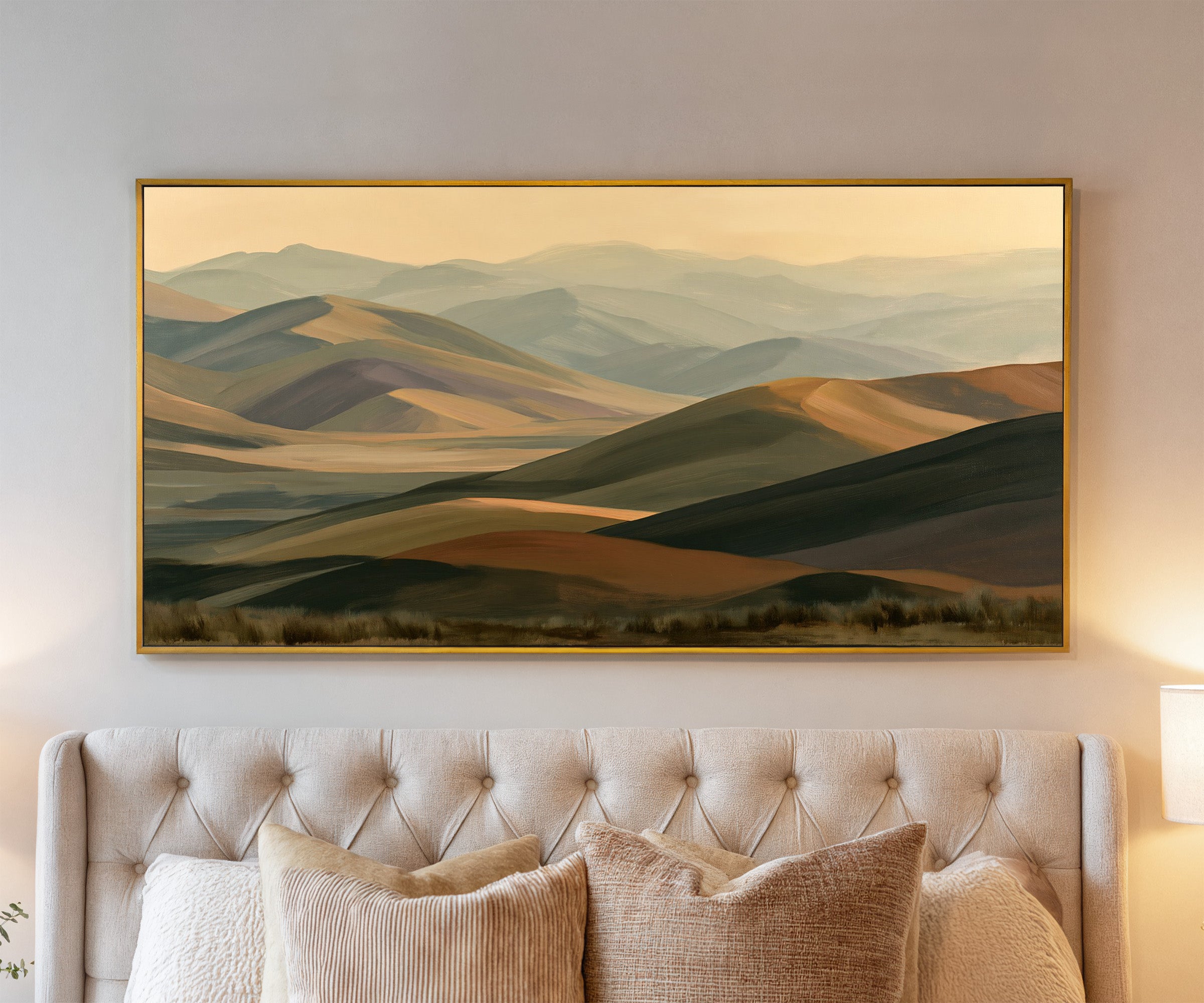 layered mountain ridges in muted gold and sage canvas wall art in a gold frame above a bed