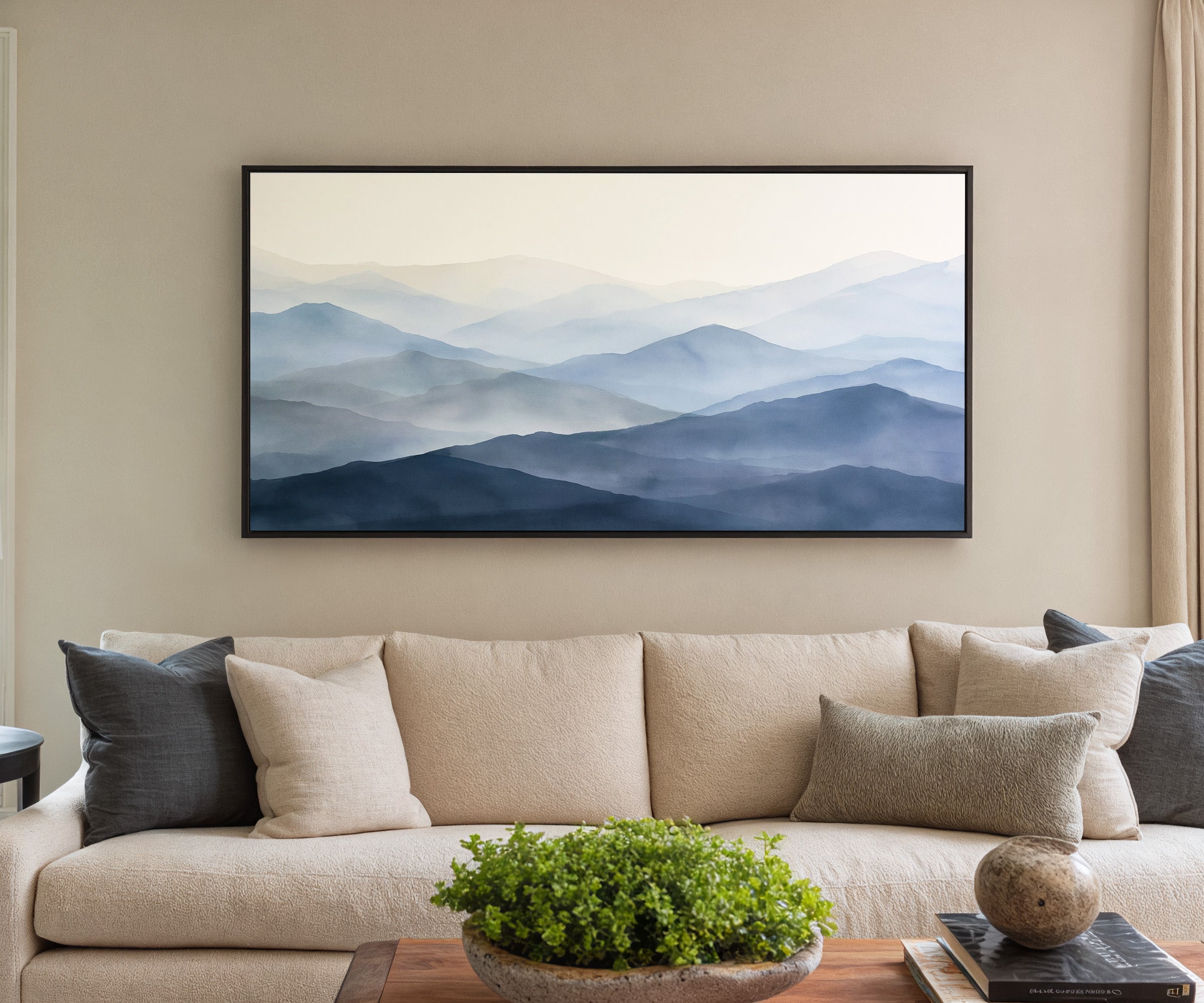 soft blue mountain layers canvas wall art in a black frame in a styled room setting