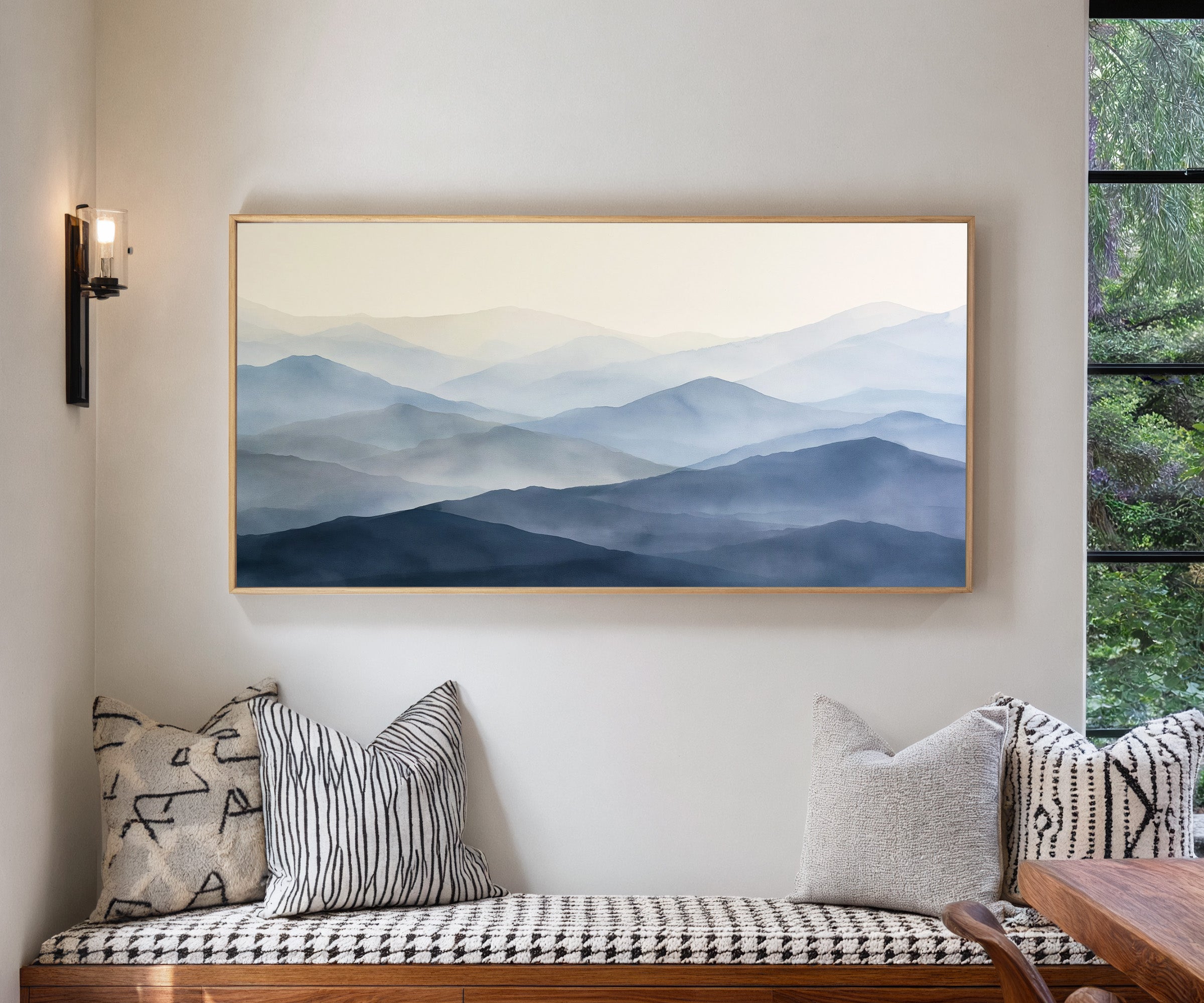 soft blue mountain layers canvas wall art in a natural wood frame in a living room
