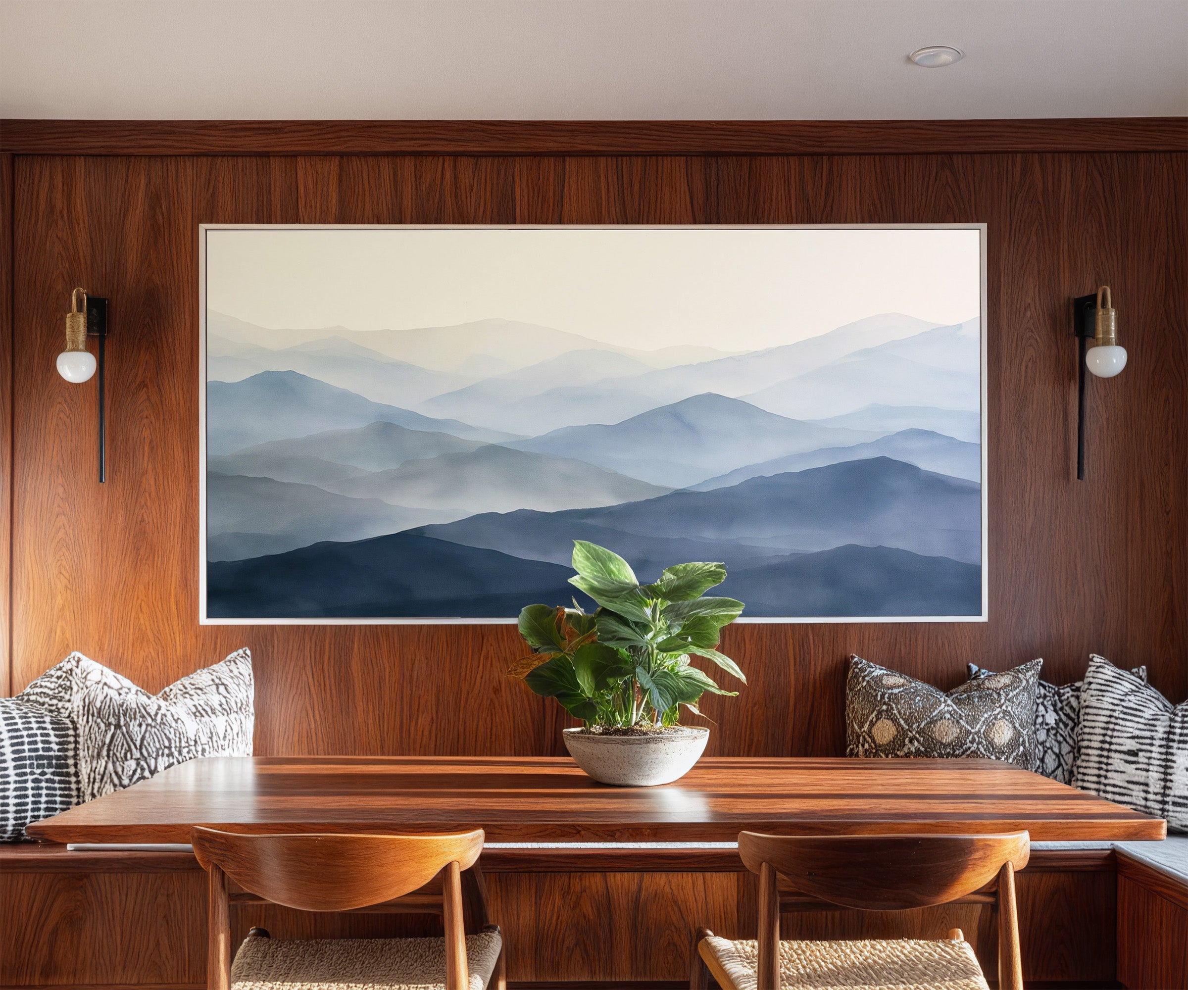 soft blue mountain layers canvas wall art in a white frame in a styled room setting