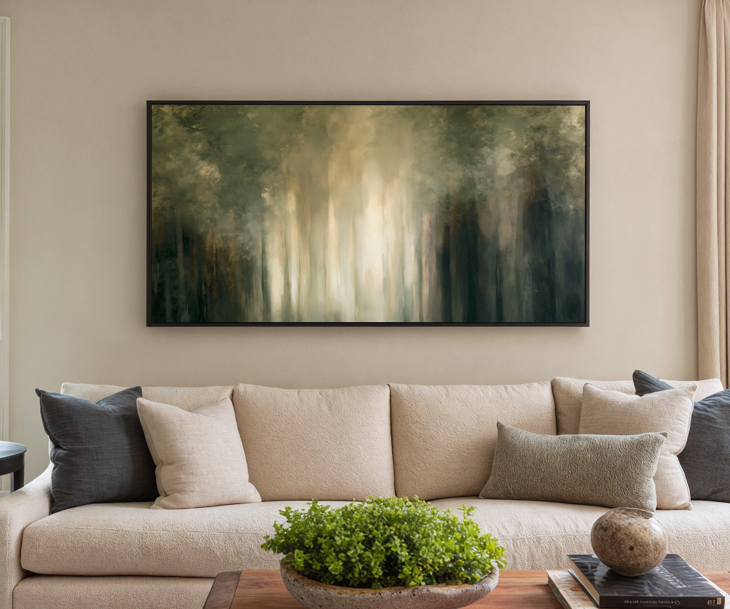 soft green and cream abstract forest with canvas wall art in a black frame in a styled room setting