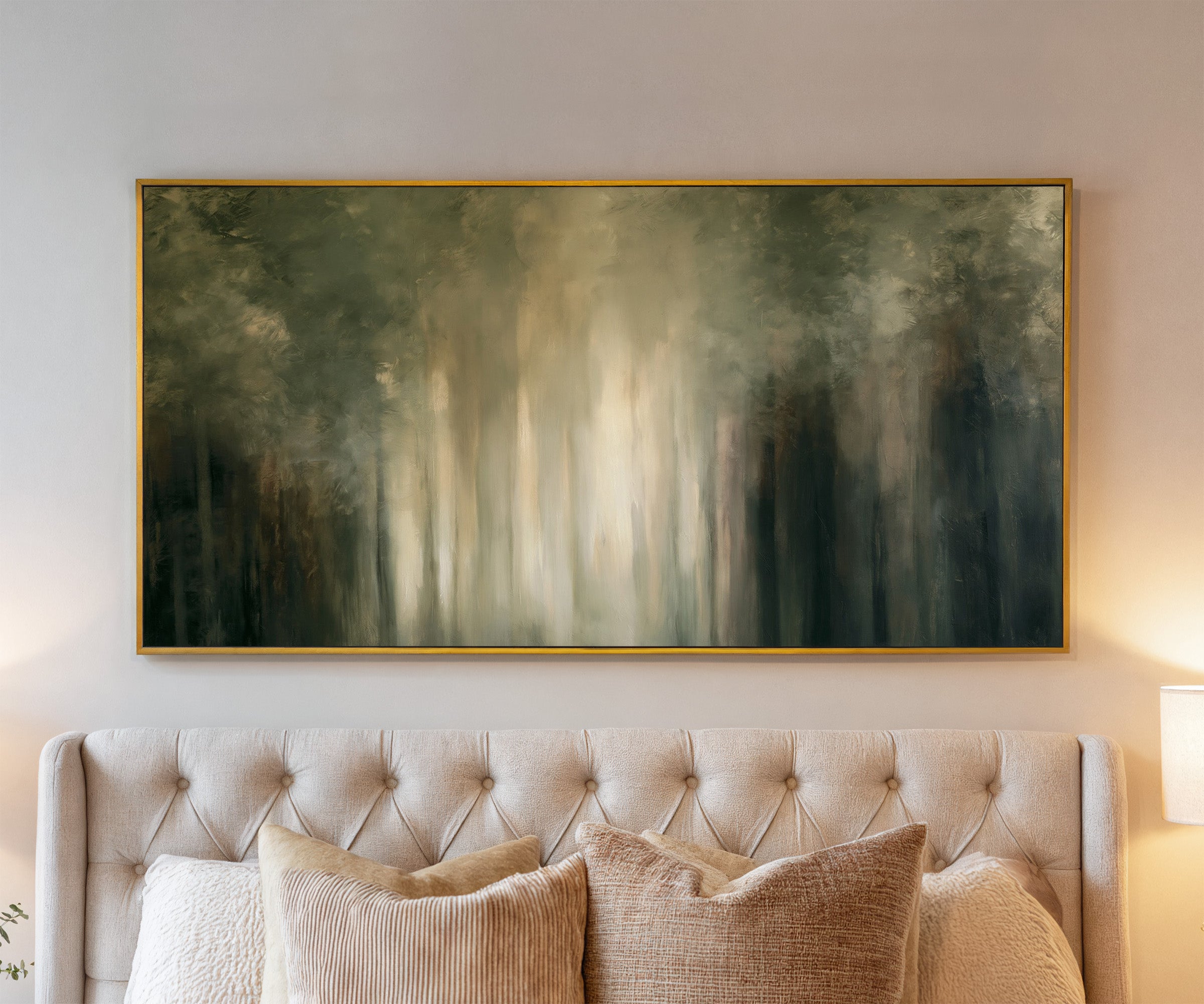 soft green and cream abstract forest with canvas wall art in a gold frame above a bed