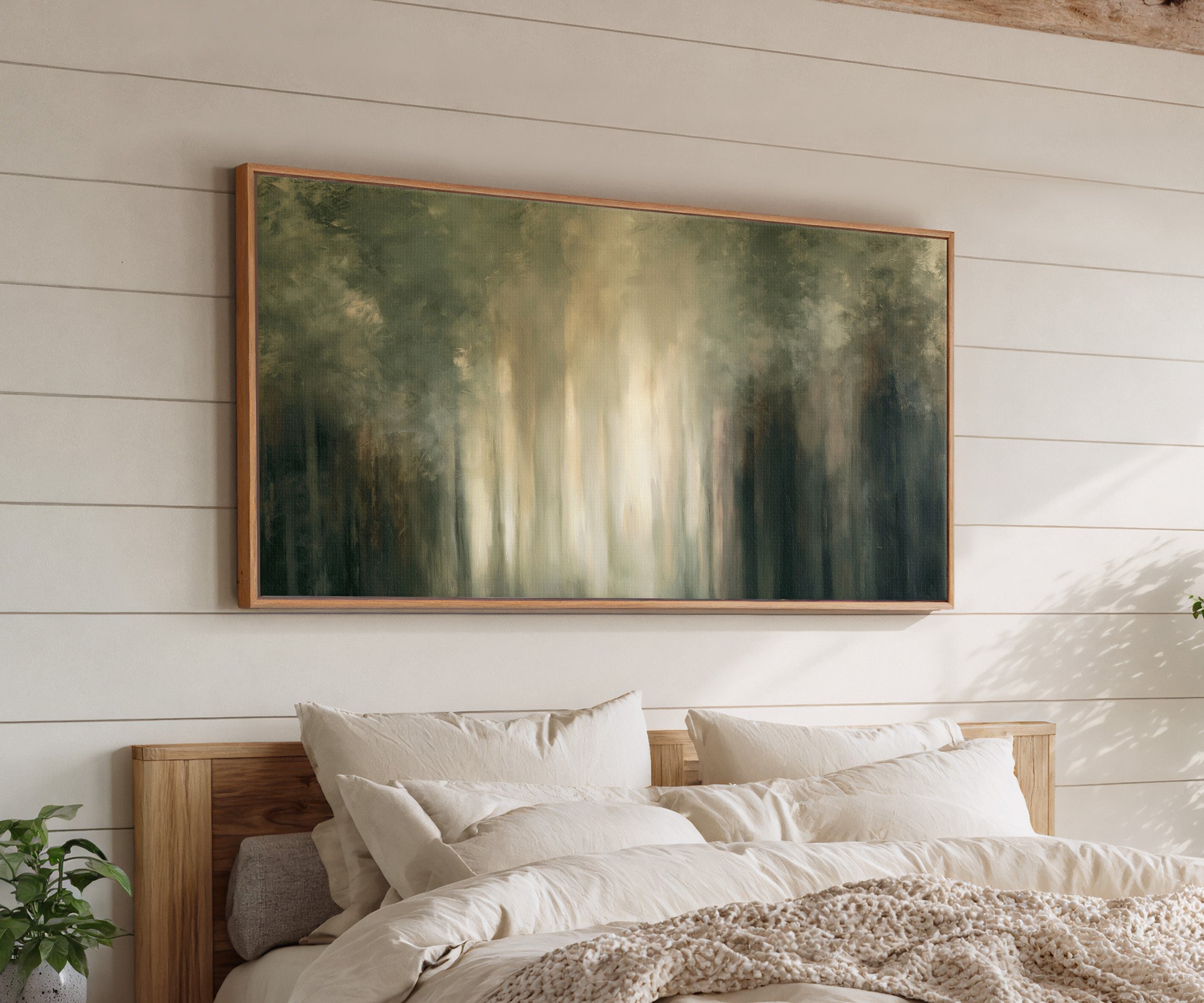 soft green and cream abstract forest with canvas wall art in an oak frame above a bed