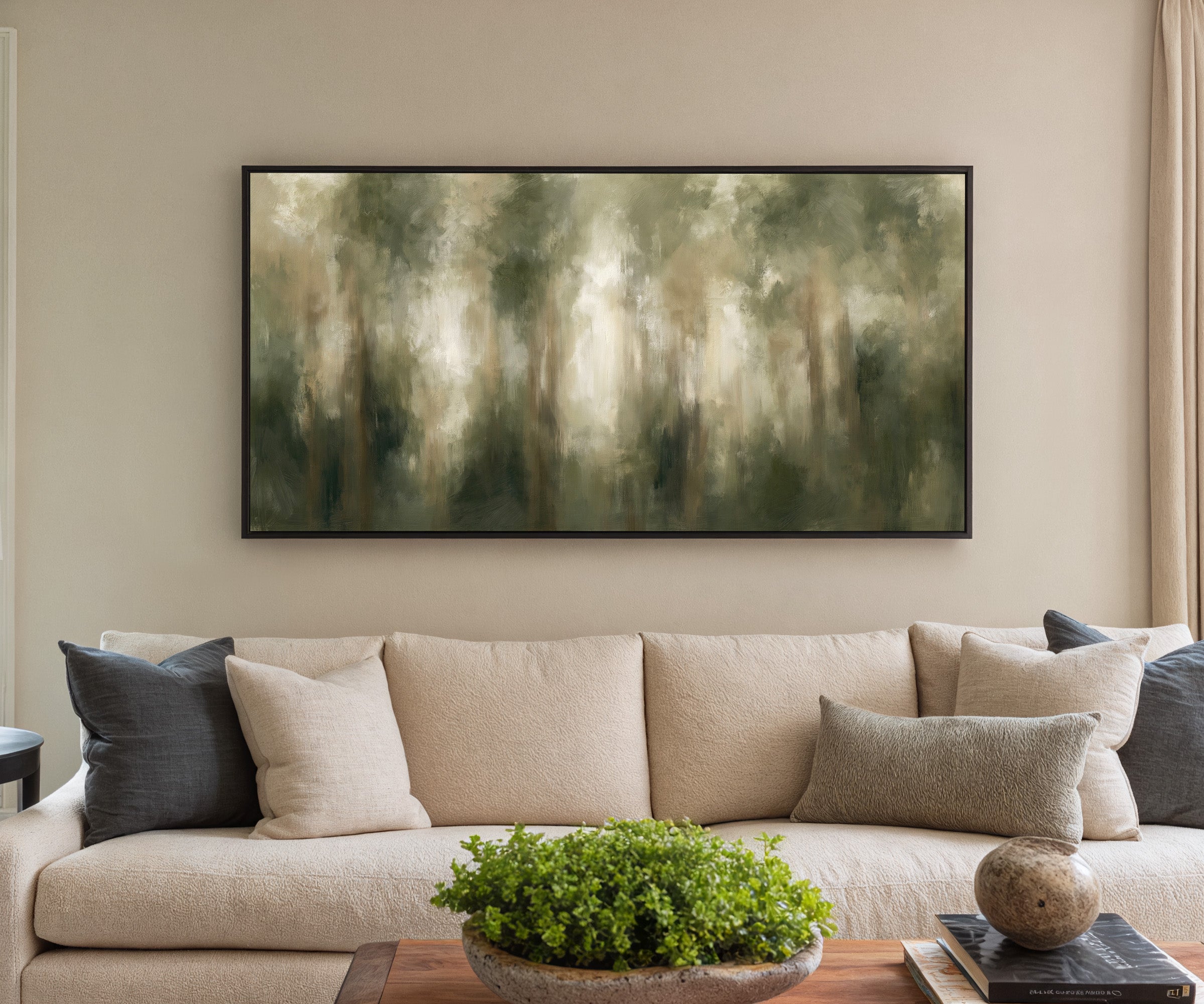 soft green and beige abstract forest canvas wall art in a black frame in a styled room setting