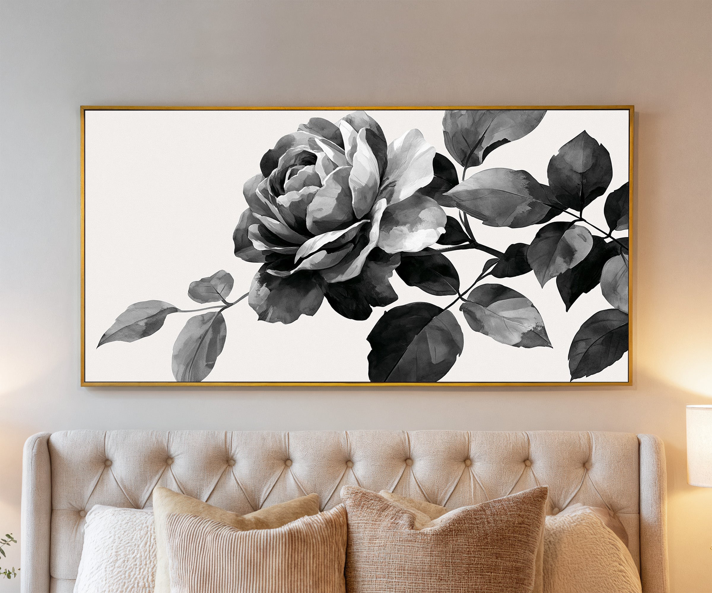 black and white floral branch canvas wall art in a gold frame above a bed