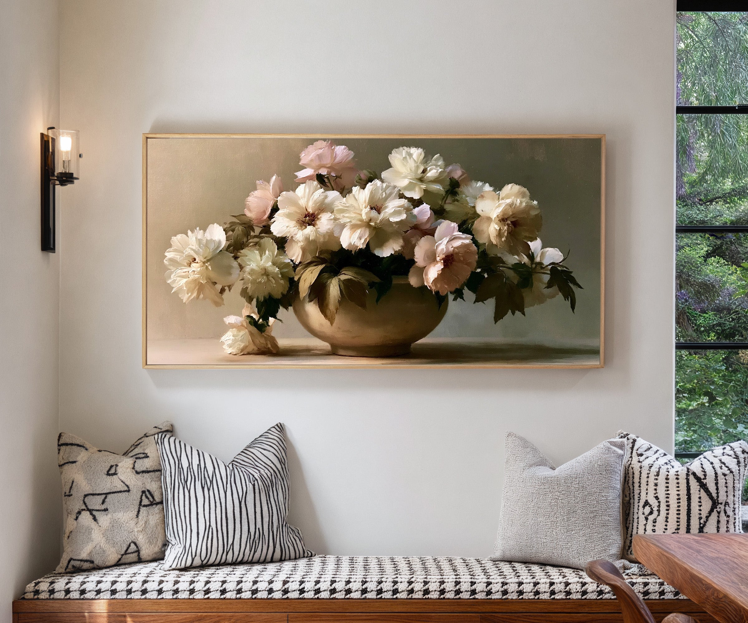 cream and pale blush floral still life canvas wall art in a natural wood frame in a living room