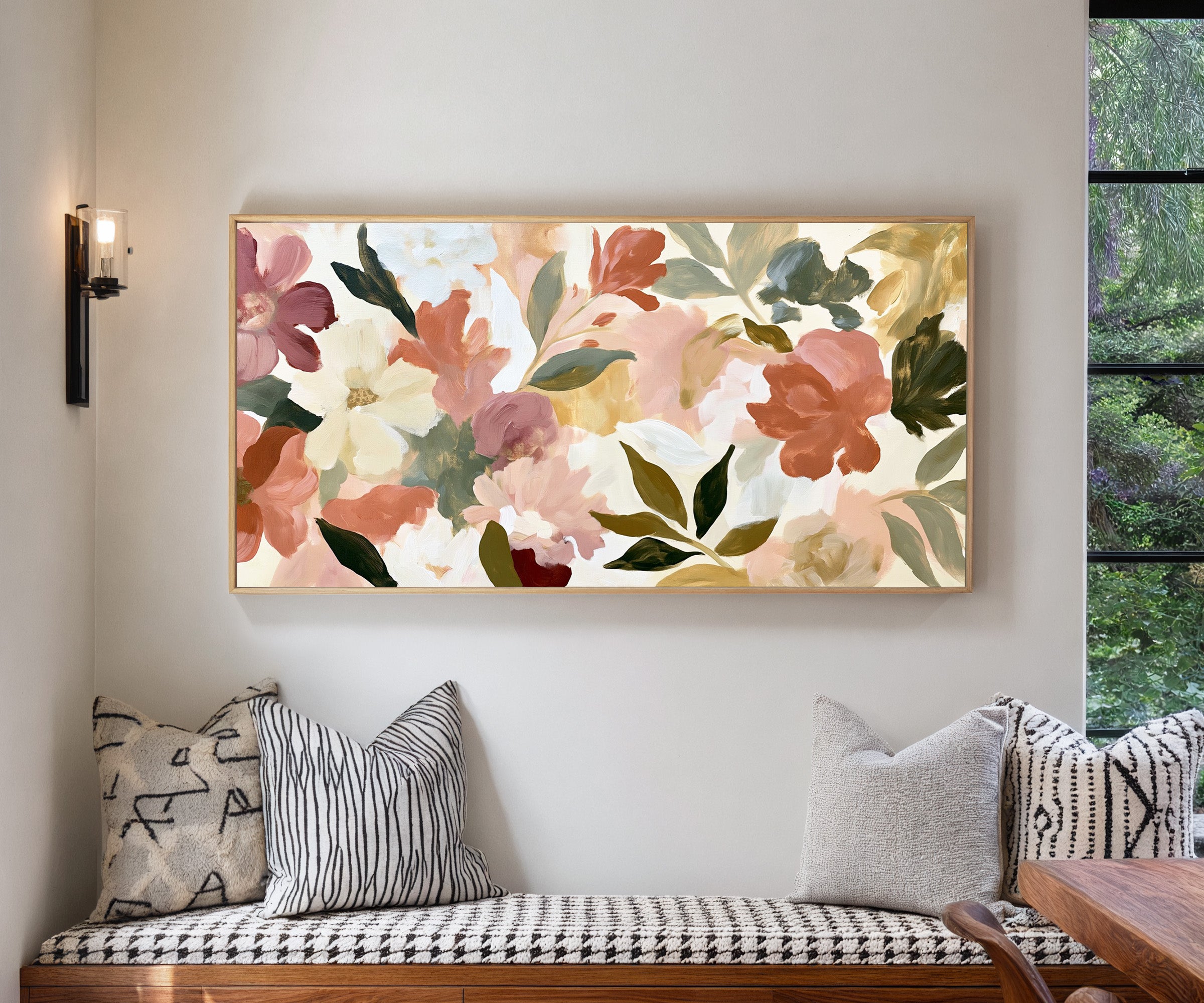 soft blush, cream, and terracotta floral forms canvas wall art in a natural wood frame in a living room