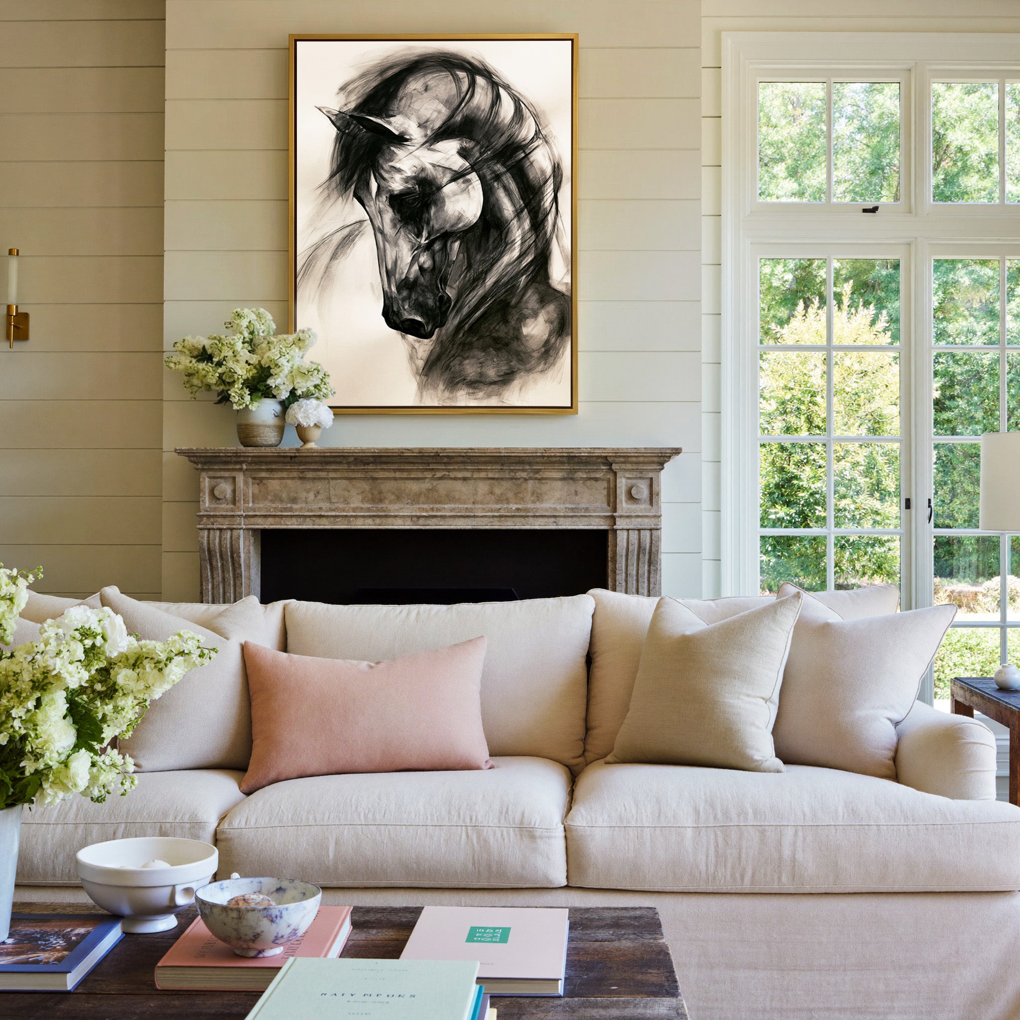 black and white horse portrait with sweeping canvas wall art in a gold frame above a mantel