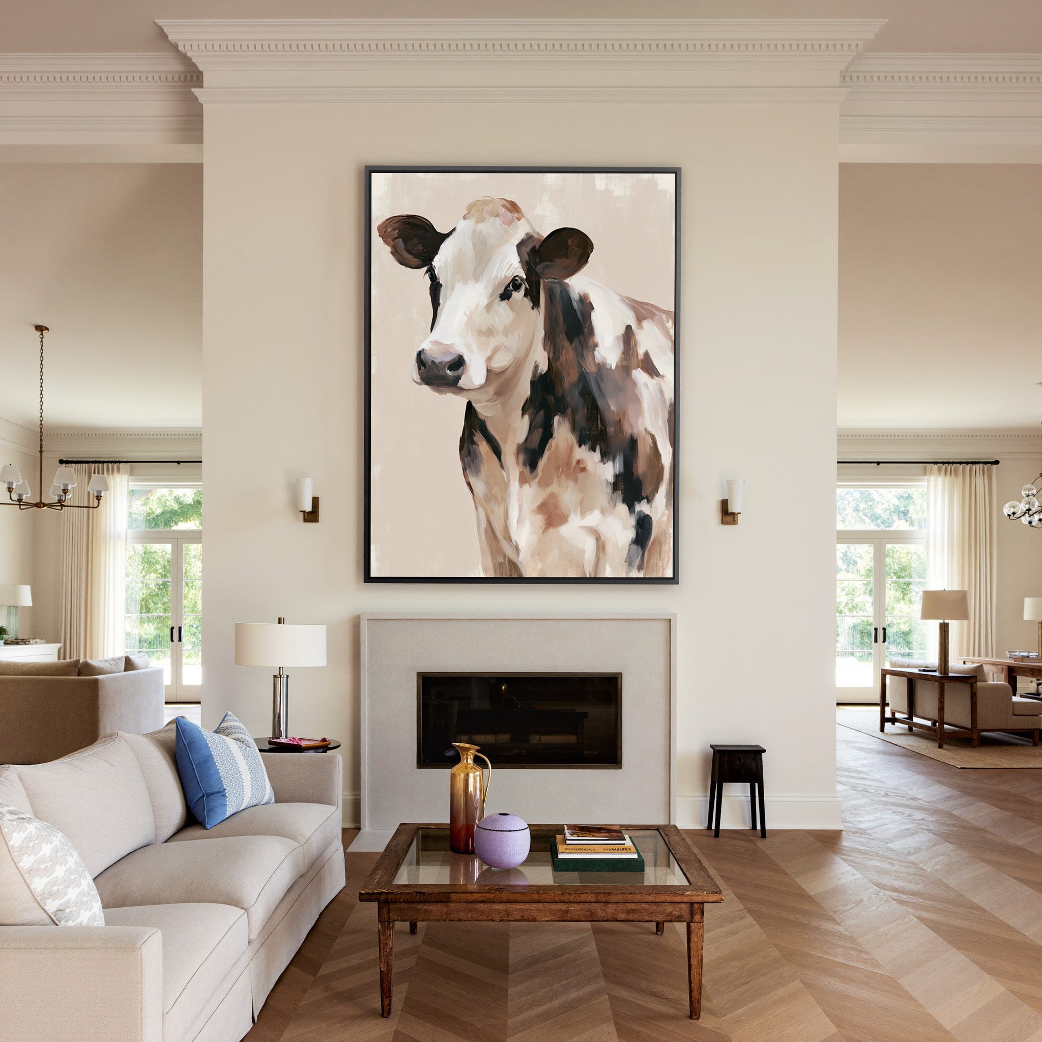cream and brown cow portrait canvas wall art in a black frame above a mantel