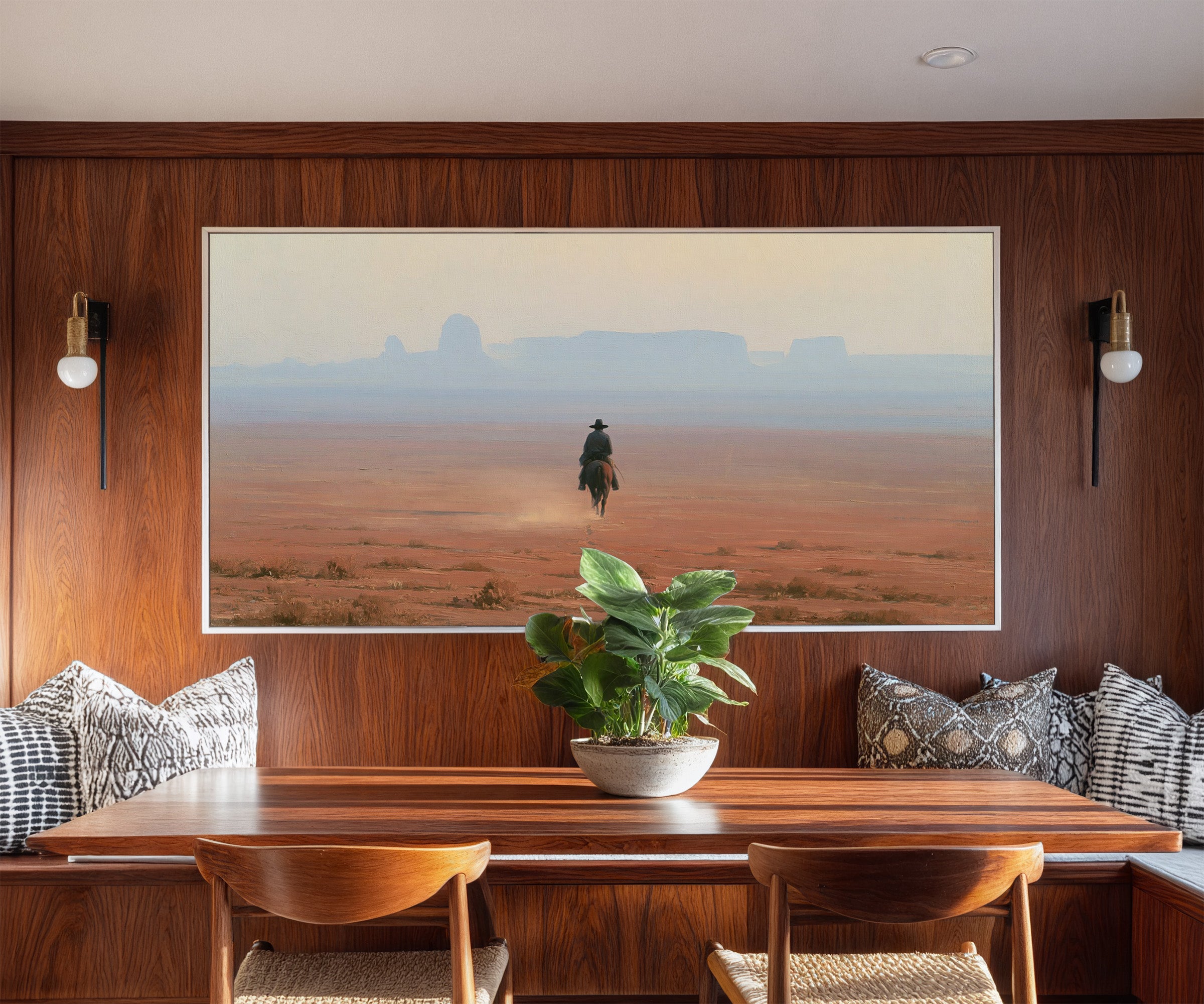 lone rider across a red desert plain with pale canvas wall art in a white frame in a styled room setting