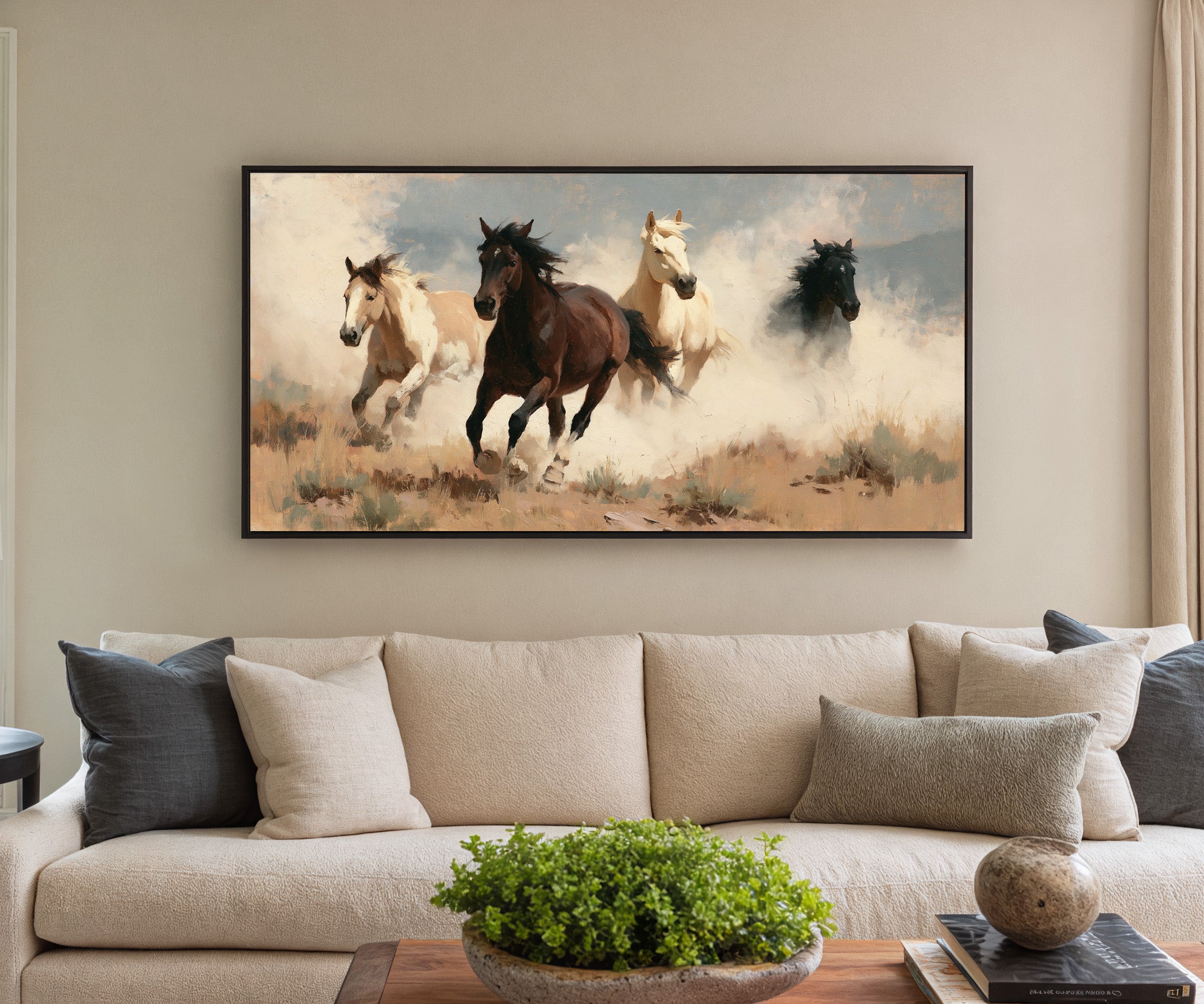 running horses in a dry open field with dust canvas wall art in a black frame in a styled room setting