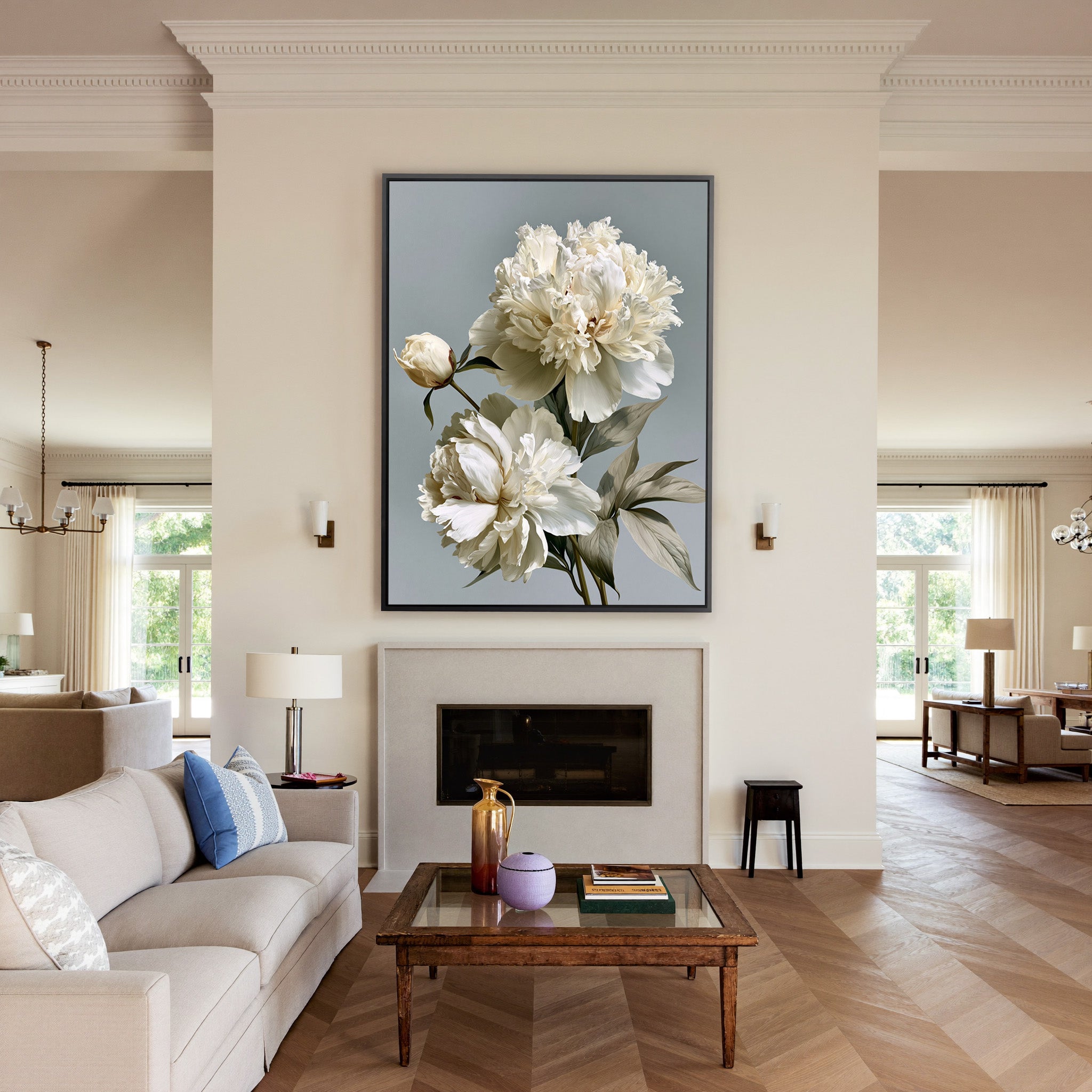 cream peonies with pale green leaves canvas wall art in a black frame above a mantel