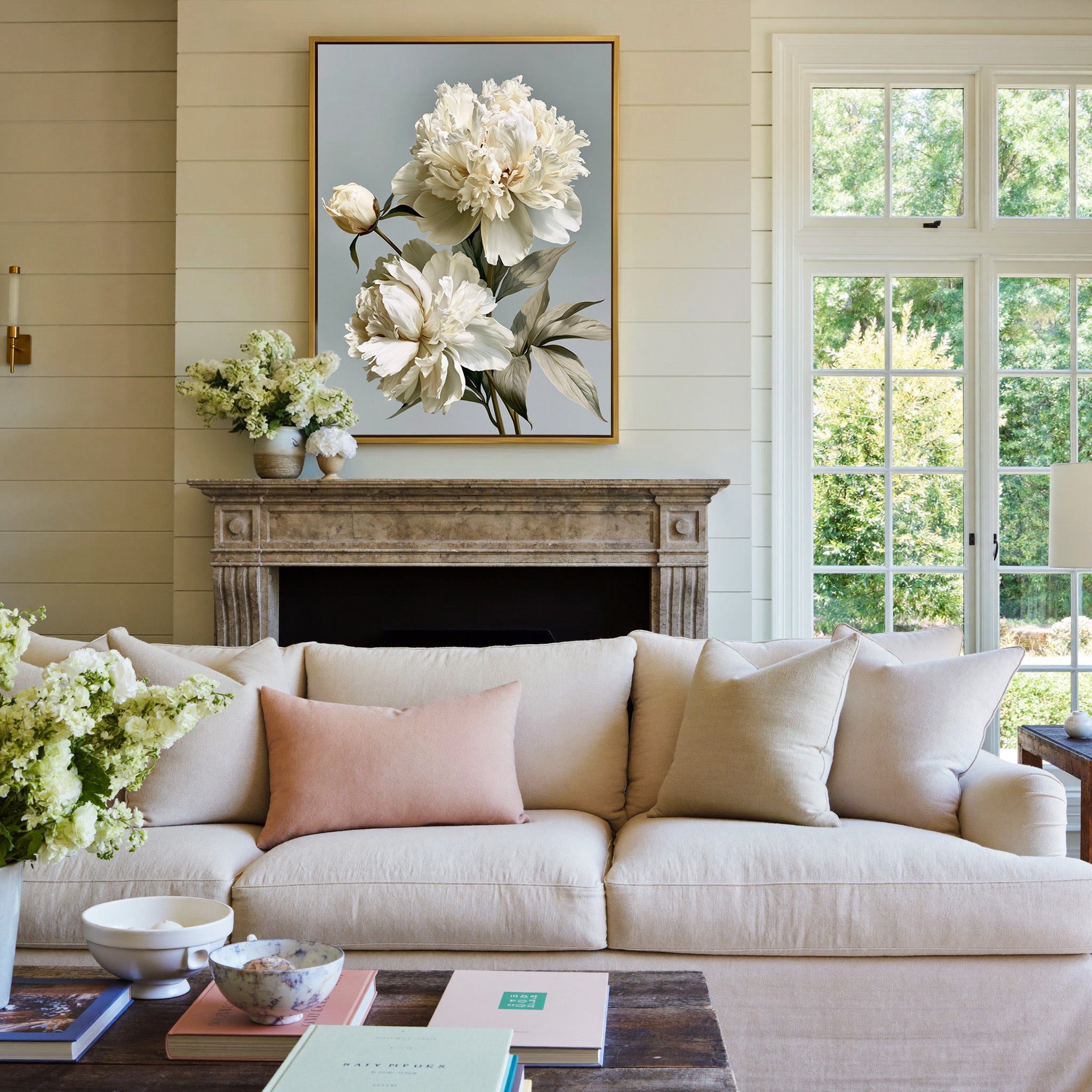 cream peonies with pale green leaves canvas wall art in a gold frame above a mantel