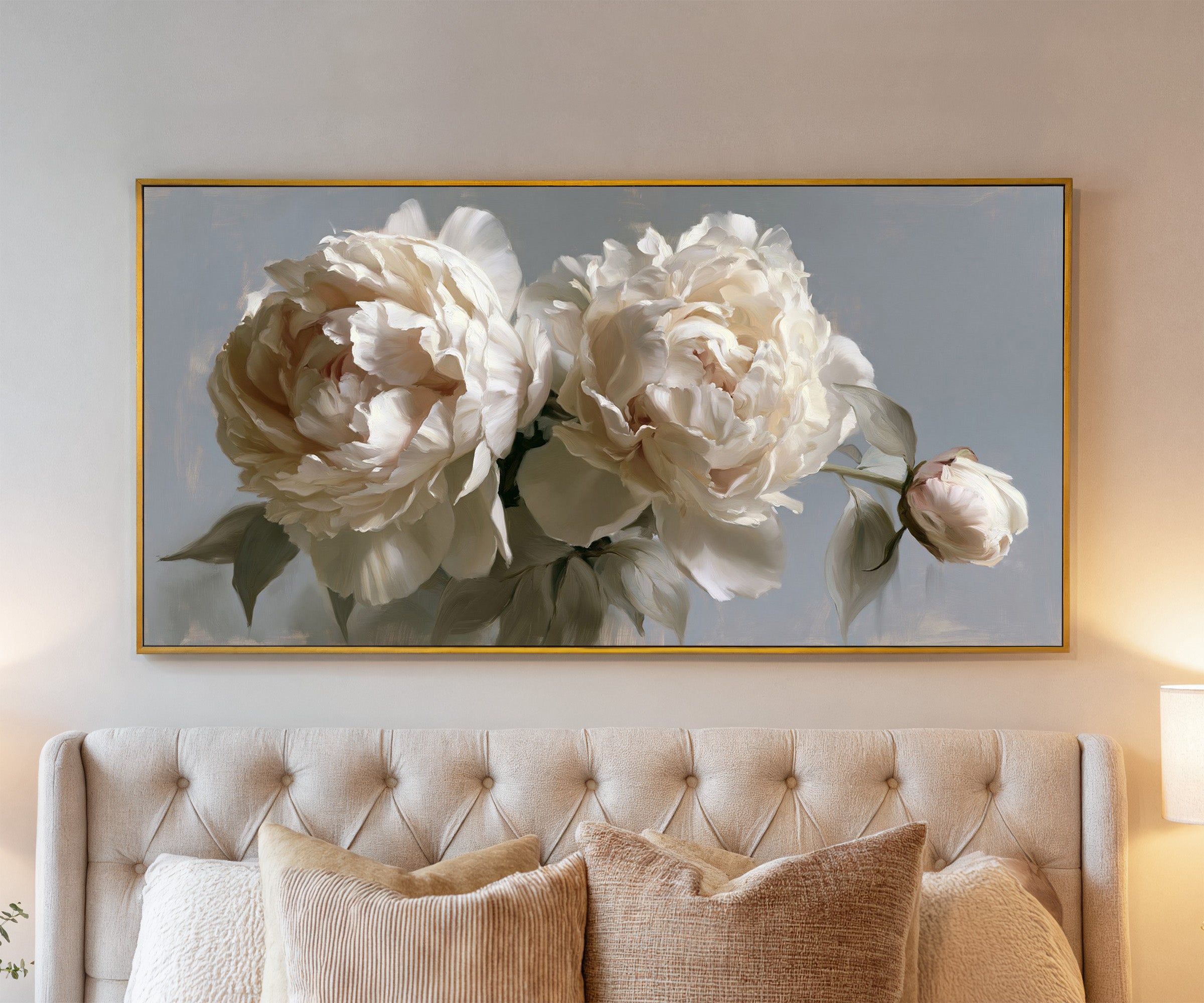 cream peonies with a single bud canvas wall art in a gold frame above a bed