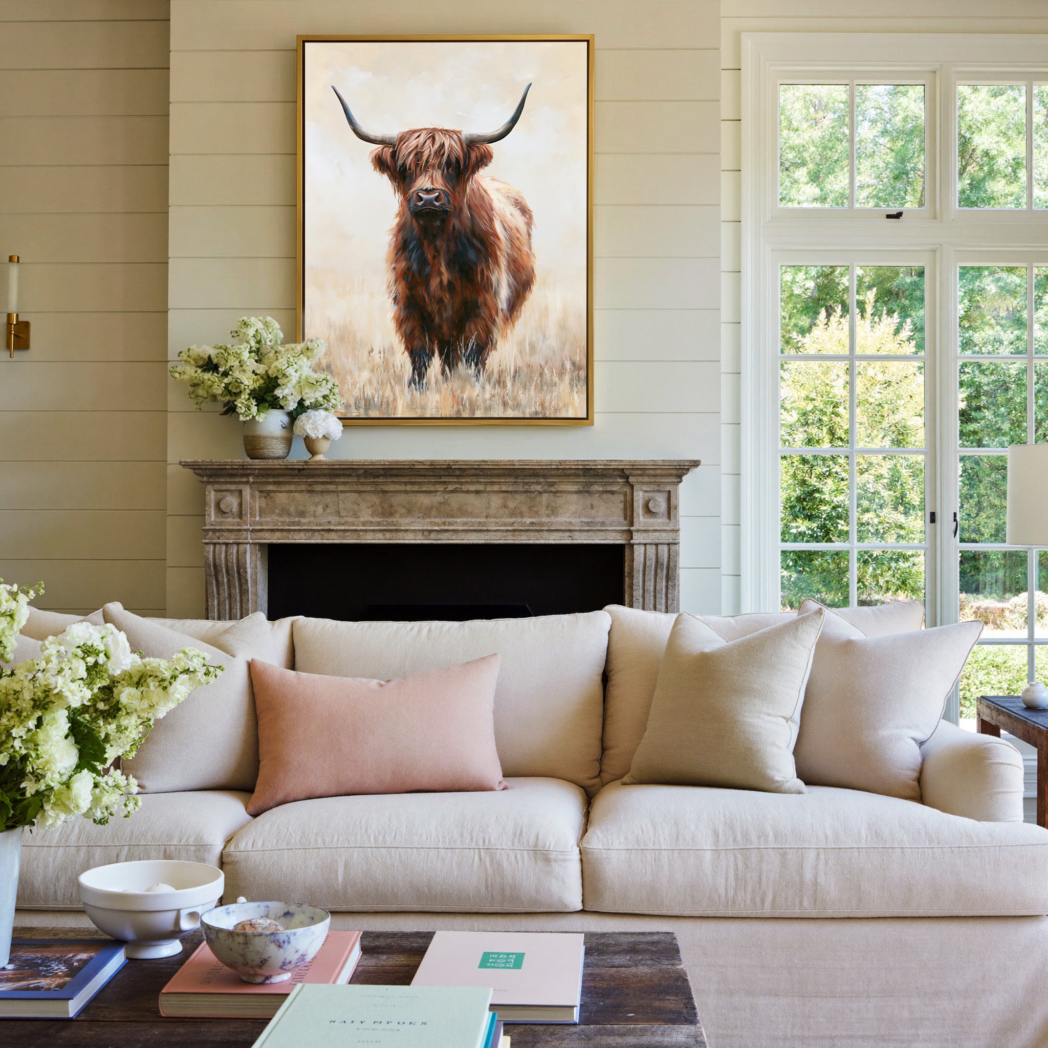 warm brown highland cow in pale dry grass canvas wall art in a gold frame above a mantel