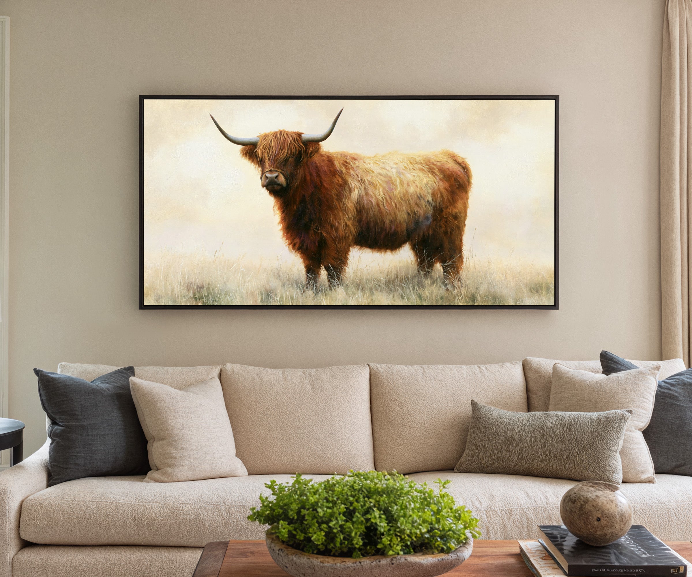 warm brown highland cow in pale dry grass canvas wall art in a black frame in a styled room setting