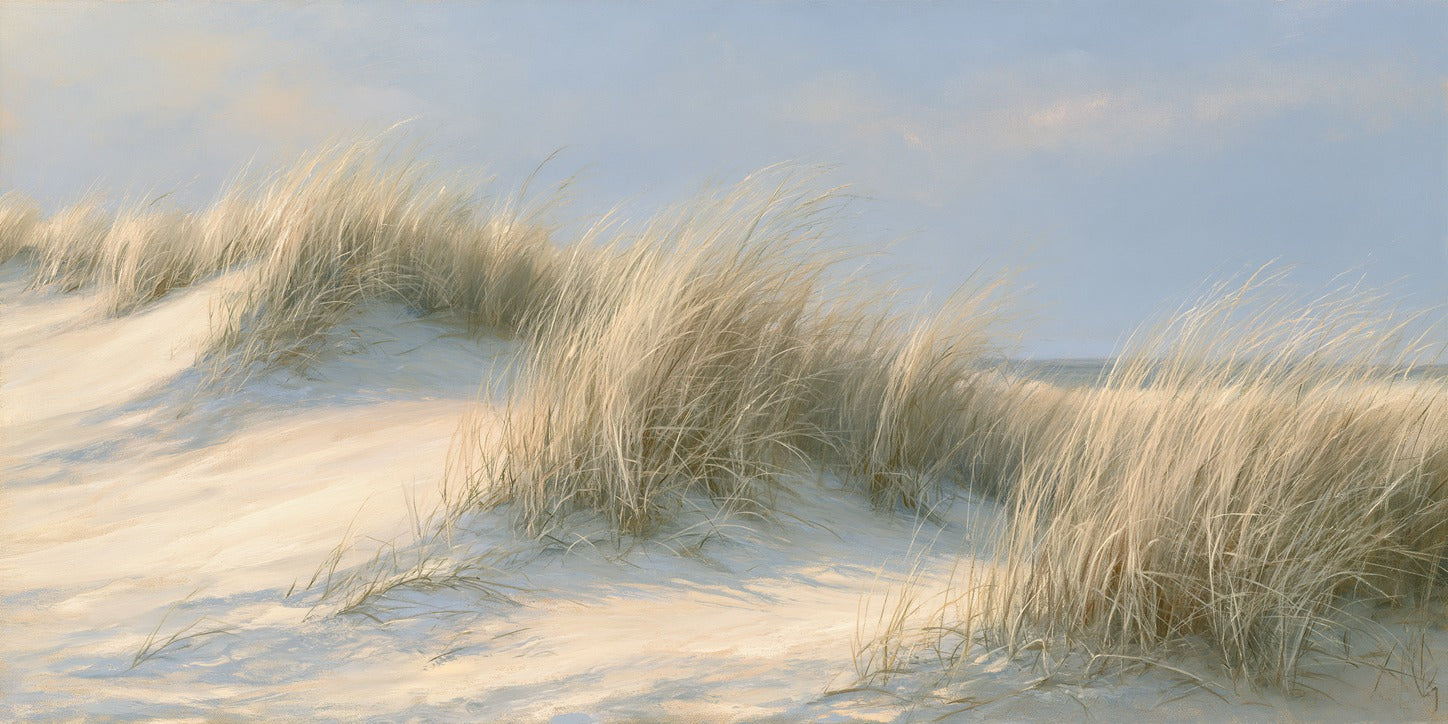 Tall pale dune grass sweeping over soft sand ridges beneath a hazy blue sky