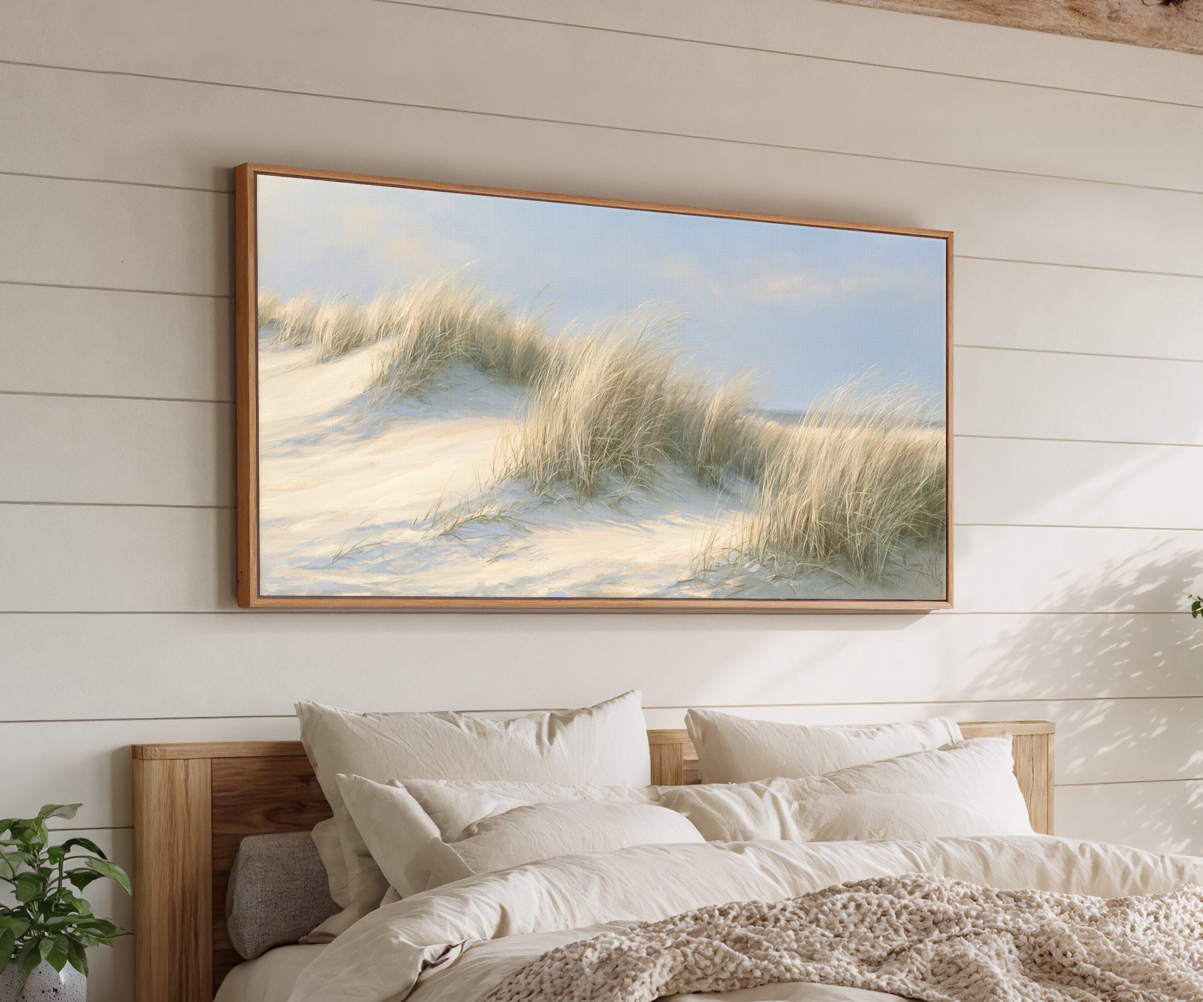 pale dune grass on soft sand canvas wall art in an oak frame above a bed