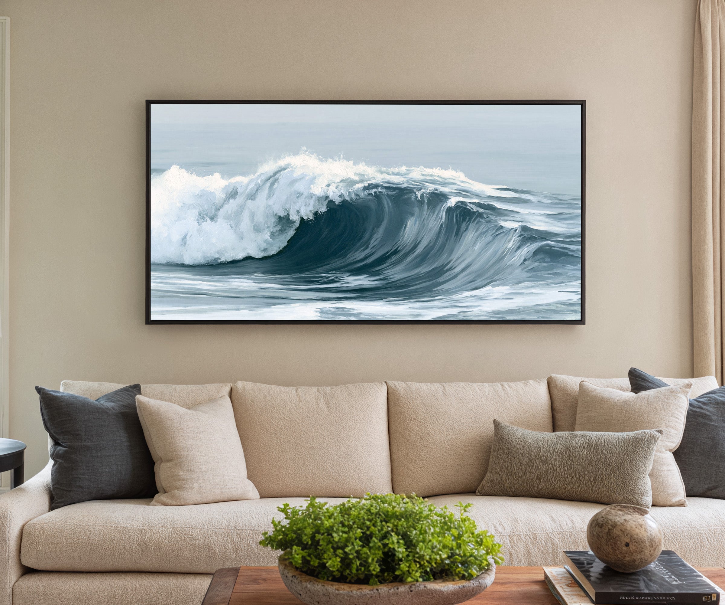 deep muted blue ocean wave canvas wall art in a black frame in a styled room setting