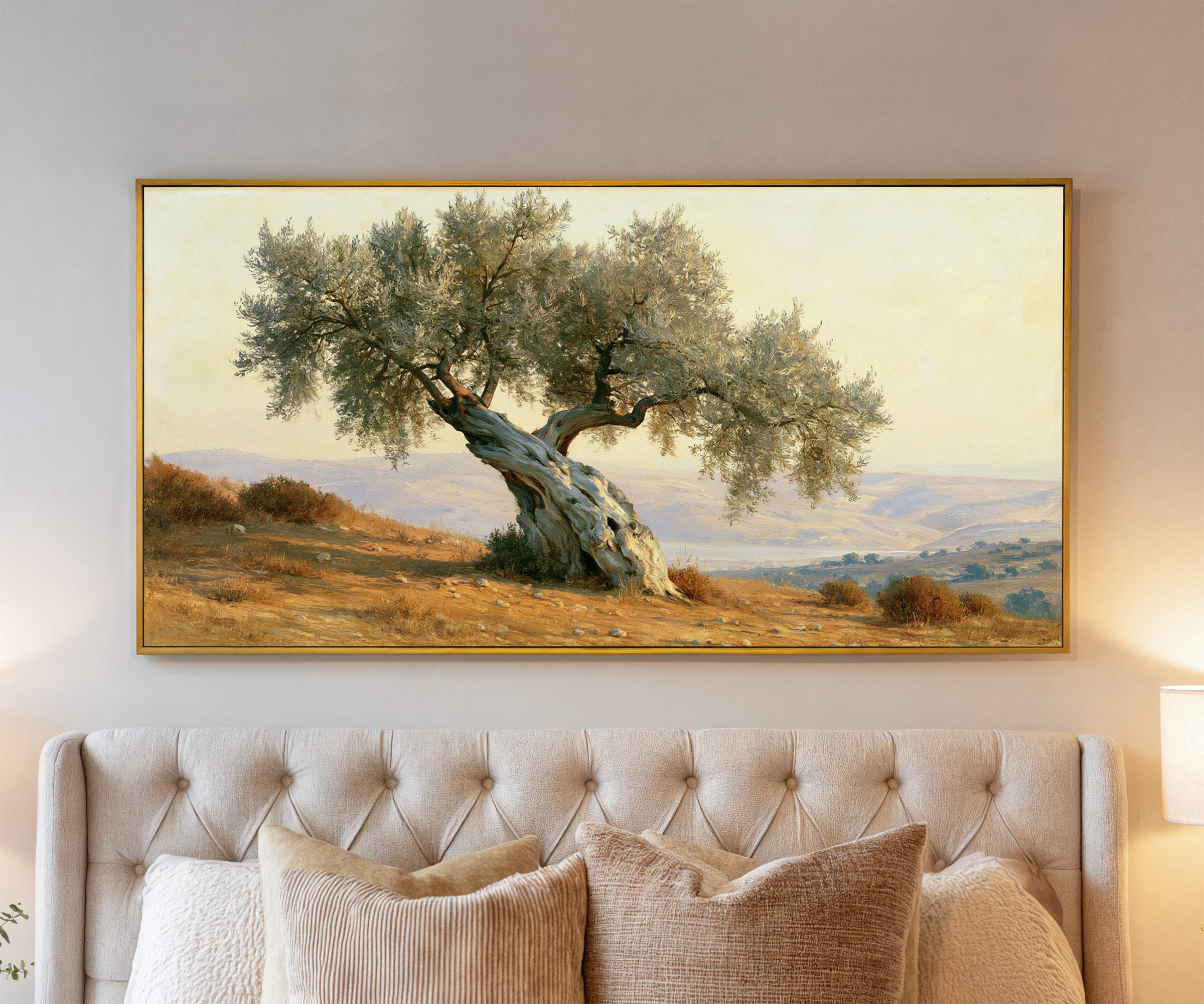 solitary olive tree on dry mediterranean hills canvas wall art in a gold frame above a bed
