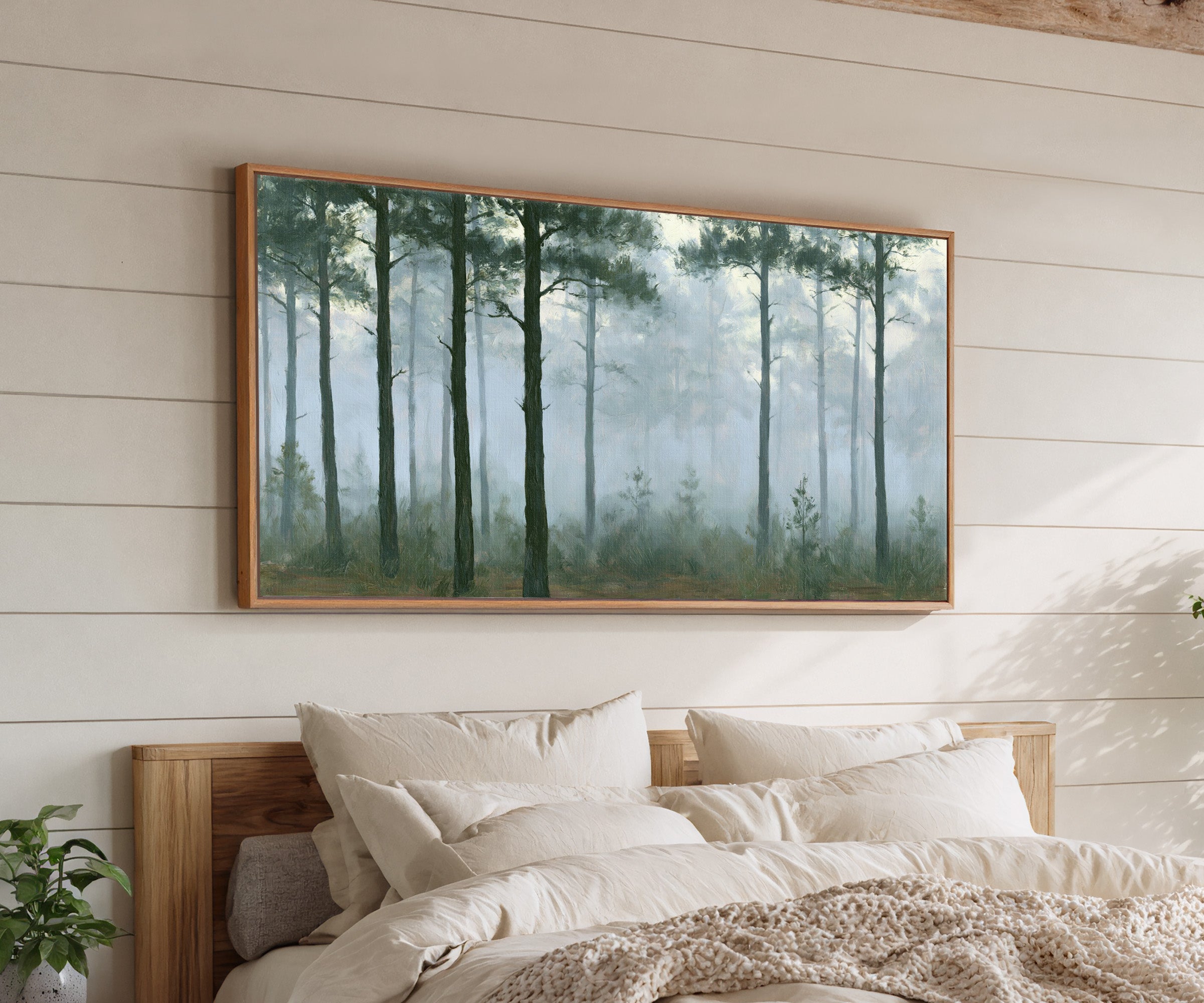 tall pines in pale morning mist canvas wall art in an oak frame above a bed