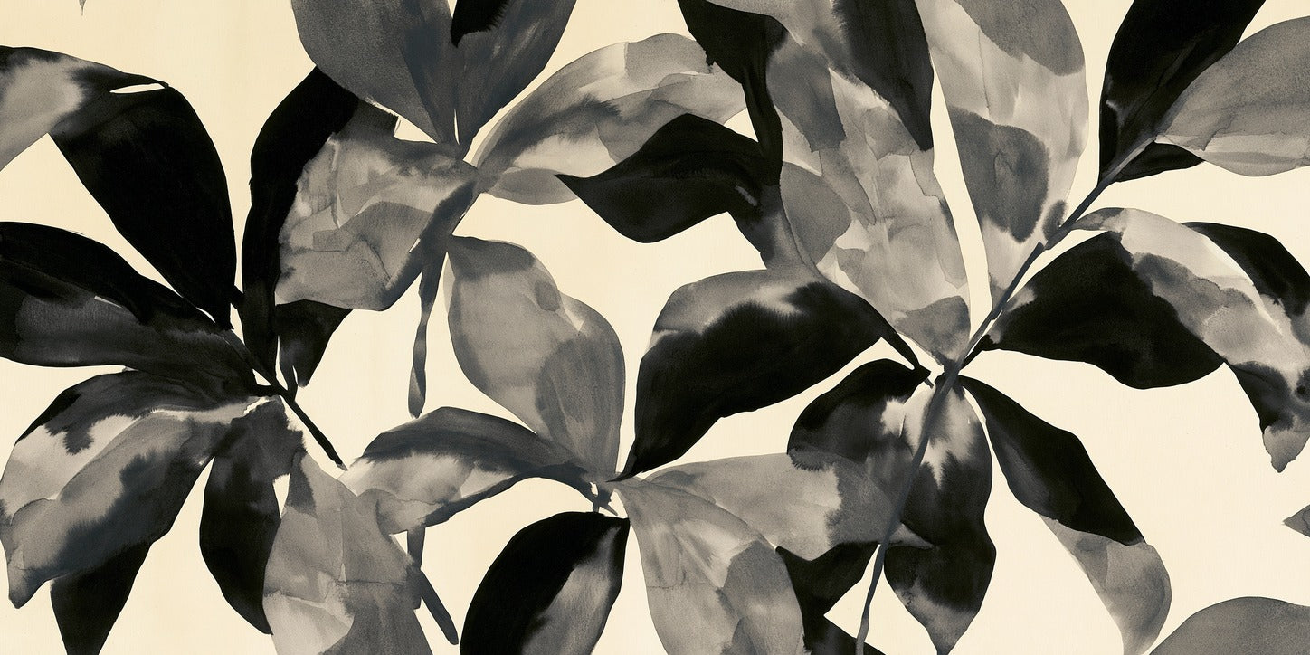 Overlapping black and gray leaf shapes spread across a cream background in a wide horizontal layout