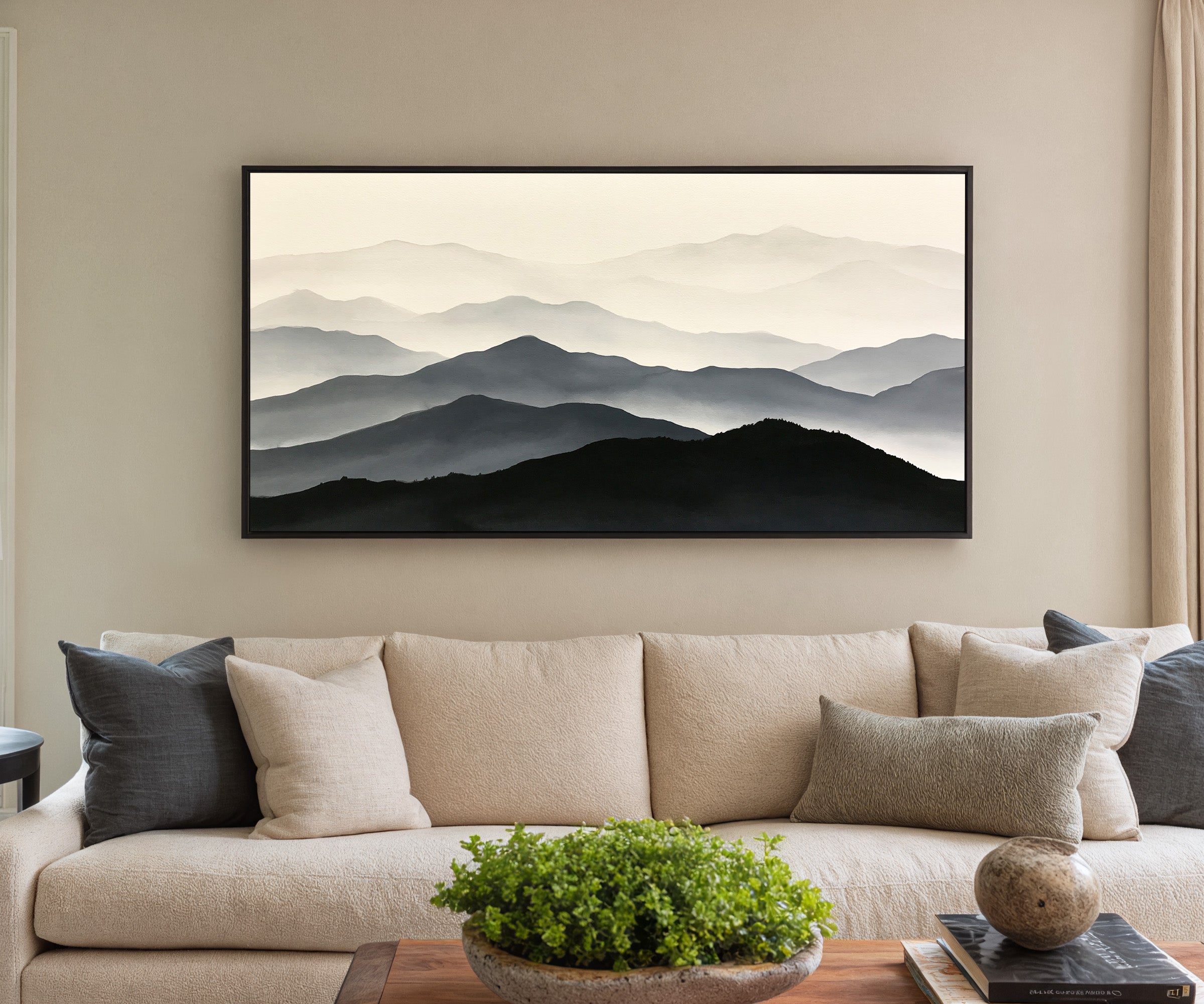 layered mountain ridges in black and gray canvas wall art in a black frame in a styled room setting
