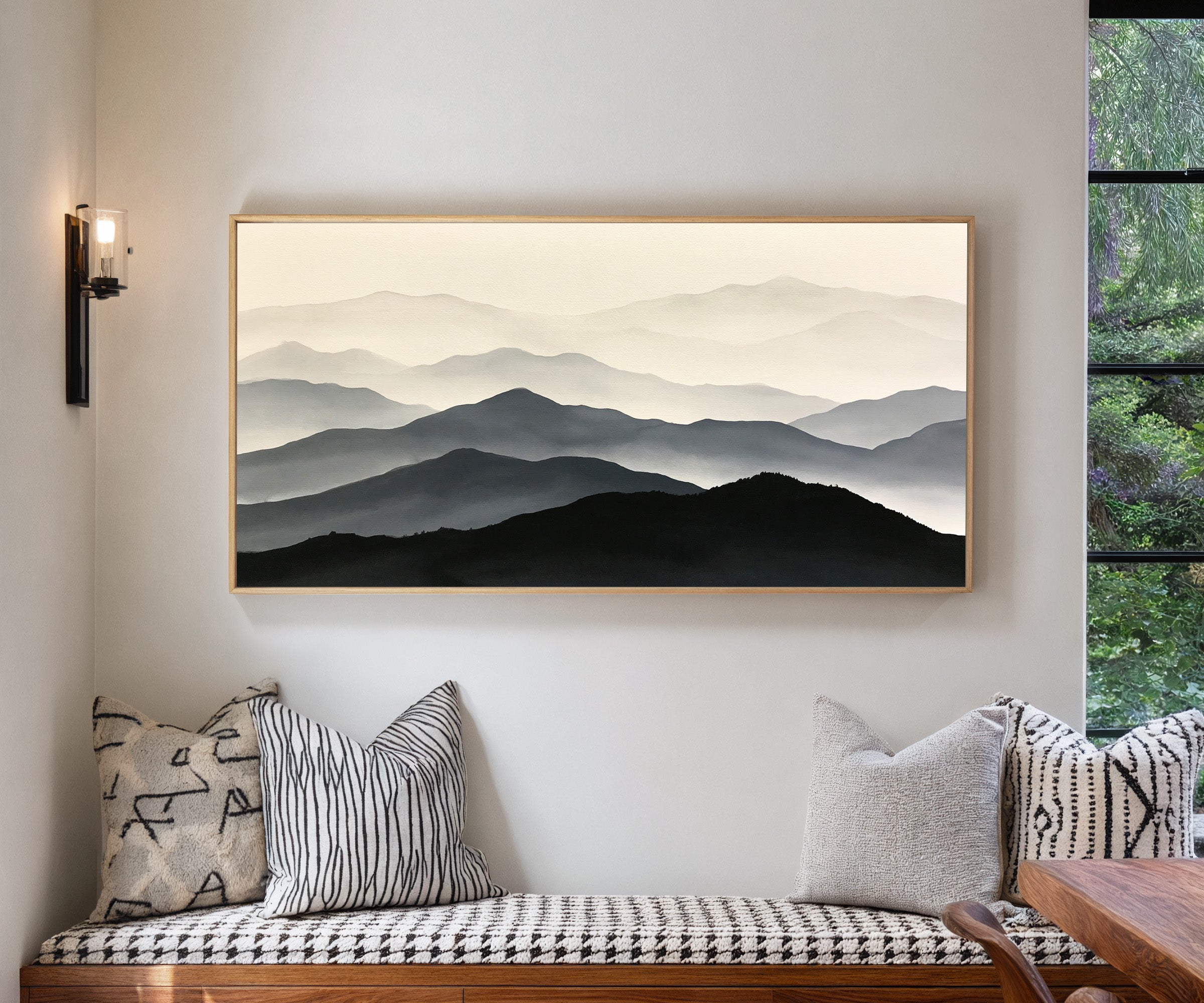 layered mountain ridges in black and gray canvas wall art in a natural wood frame in a living room