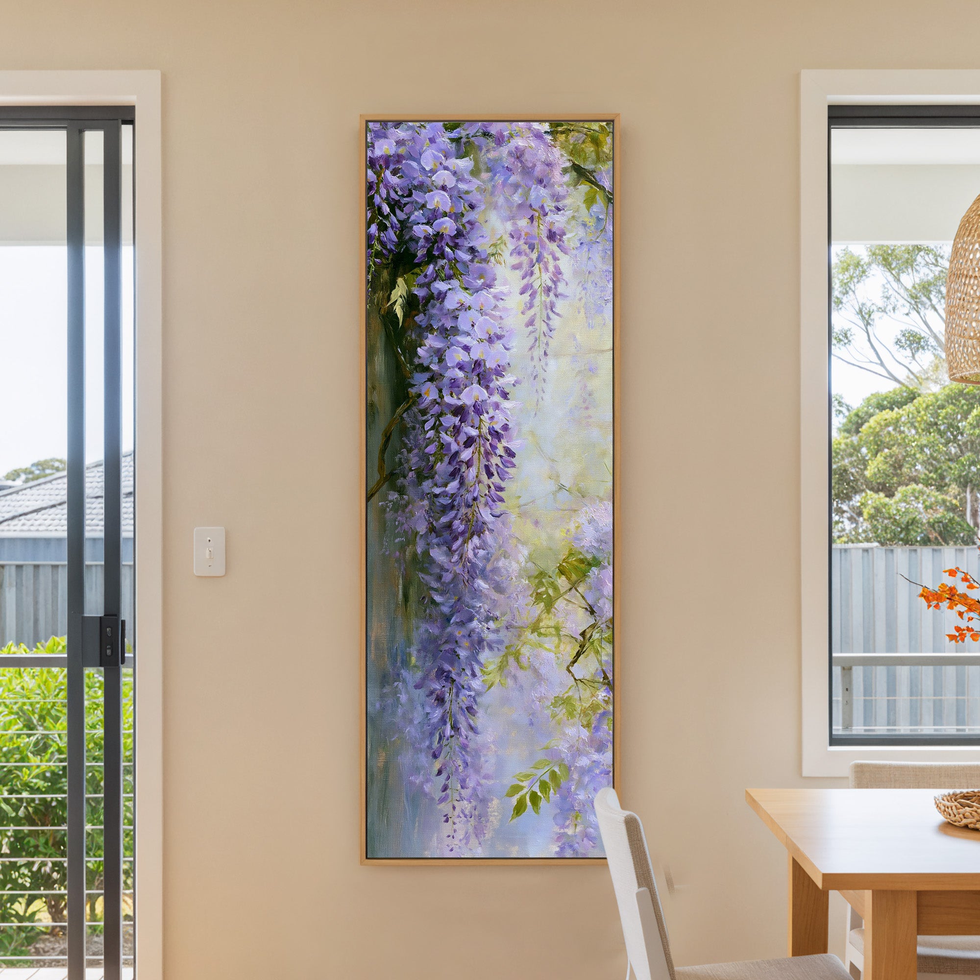 cascading lavender wisteria against a pale canvas wall art in a natural wood frame in a dining room