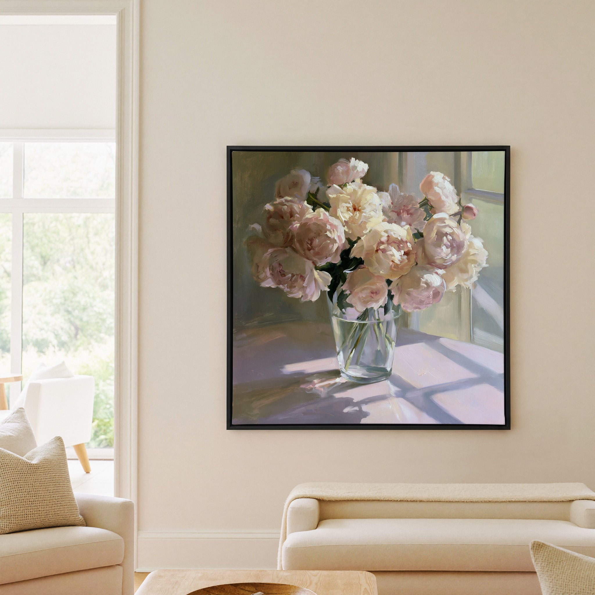 soft blush and cream peony bouquet in a glass canvas wall art in a black frame in a living room