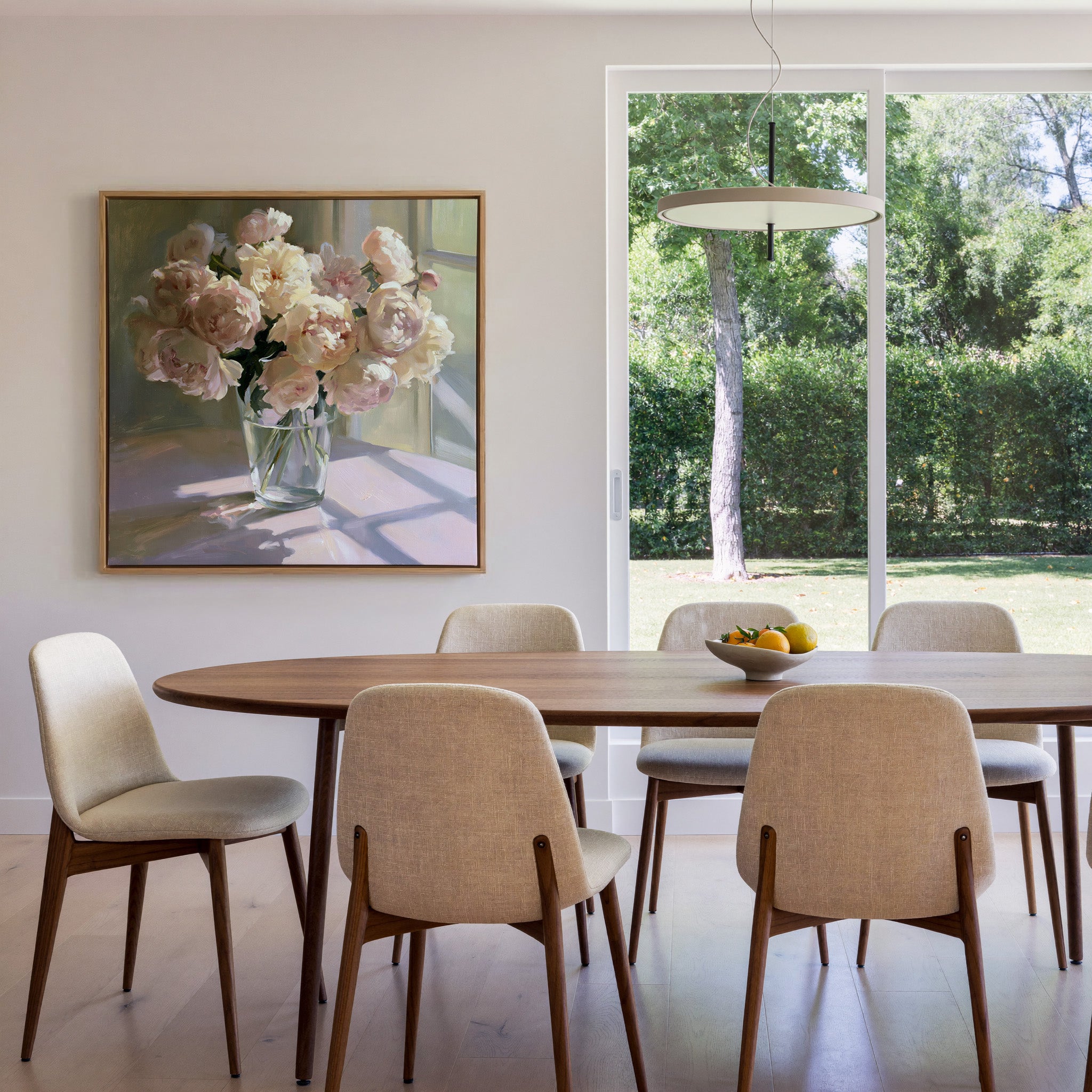 soft blush and cream peony bouquet in a glass canvas wall art in an oak frame in a dining room