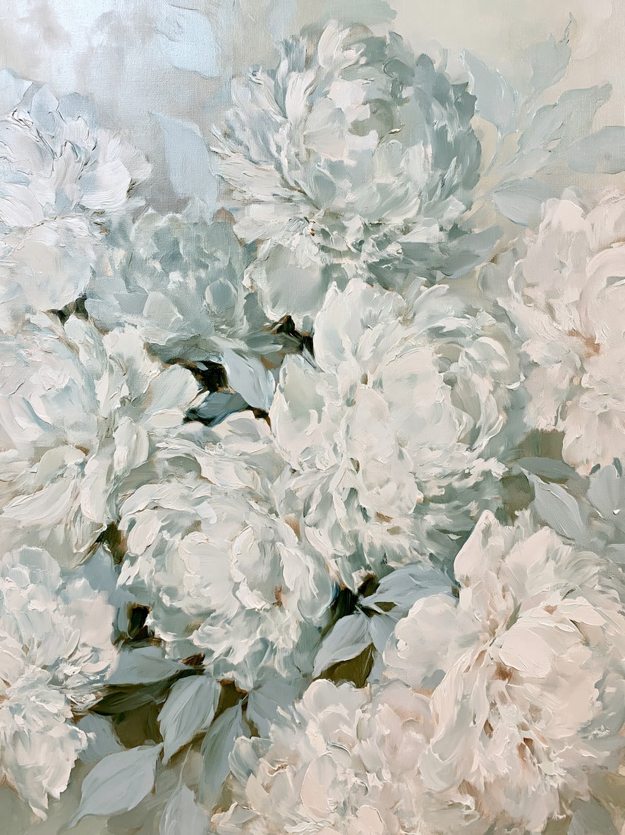 Layered white and blush peonies with pale sage leaves filling the frame